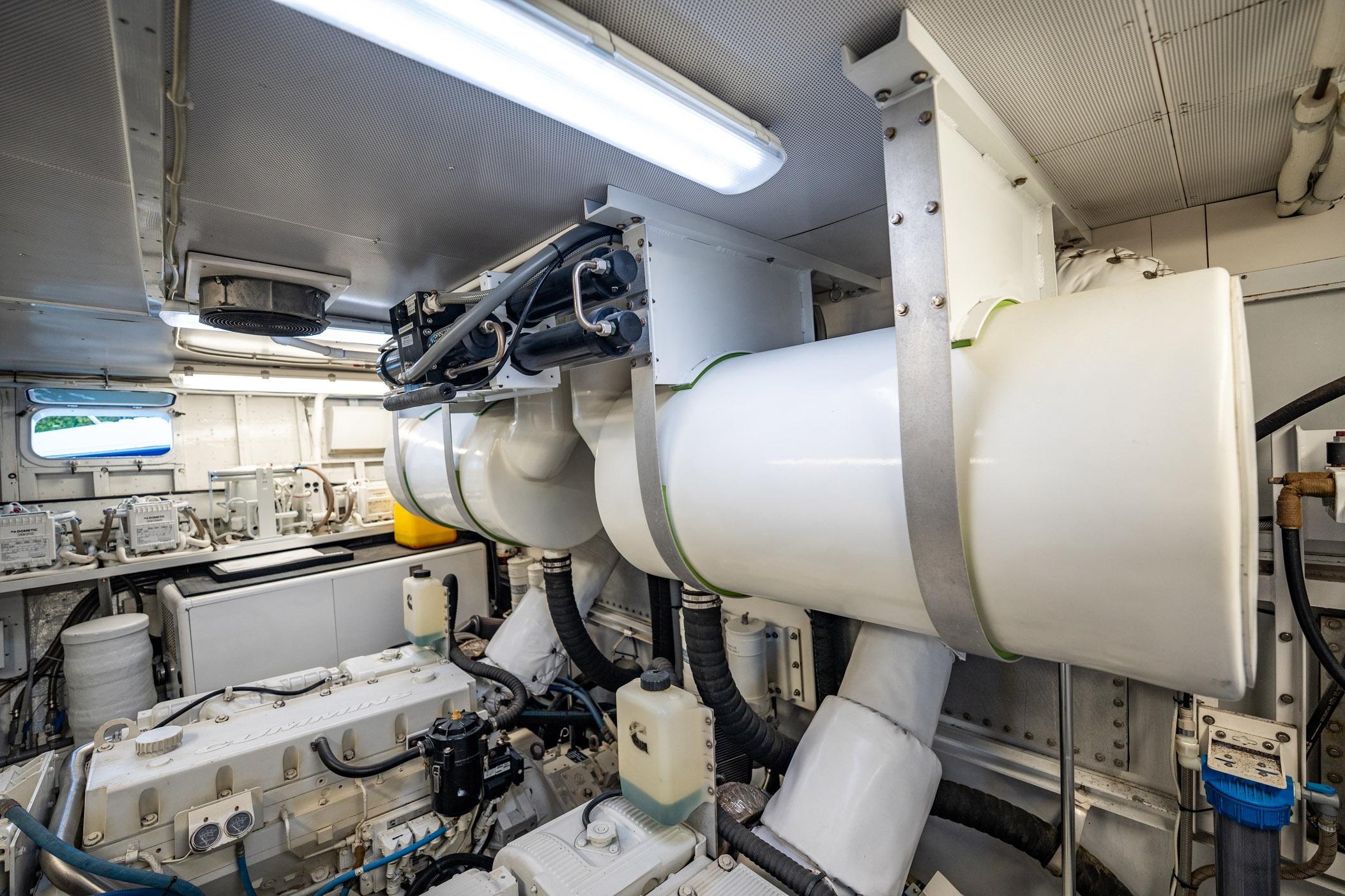 Engine room of a 1972 Trumpy 72 Motor Yacht, showcasing machinery and equipment.