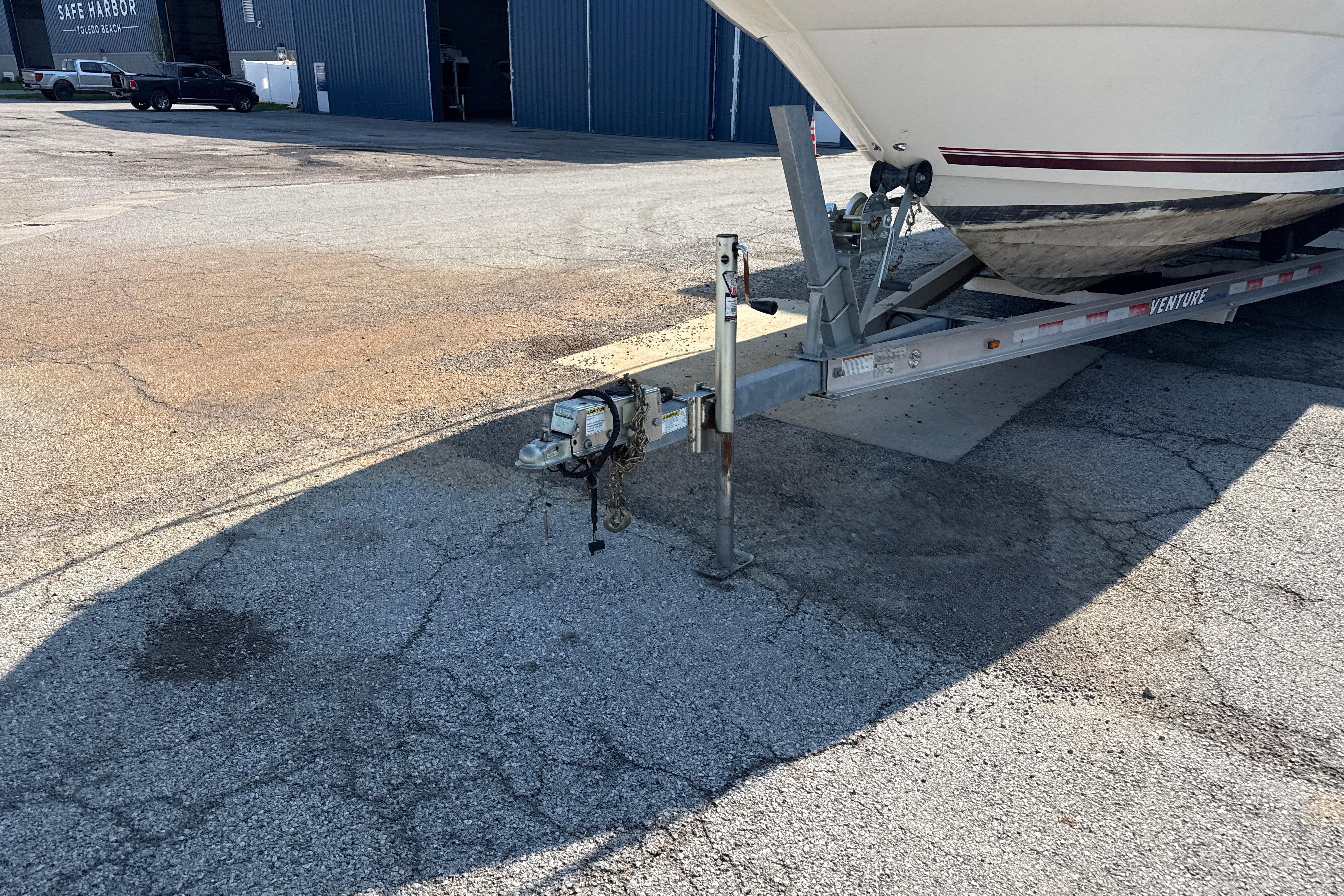 1996 Sea Ray 240 Sundancer on trailer in marina parking lot.