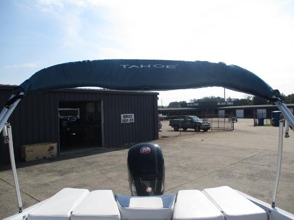 2023 Tahoe 185 S boat with canopy, parked near service area.