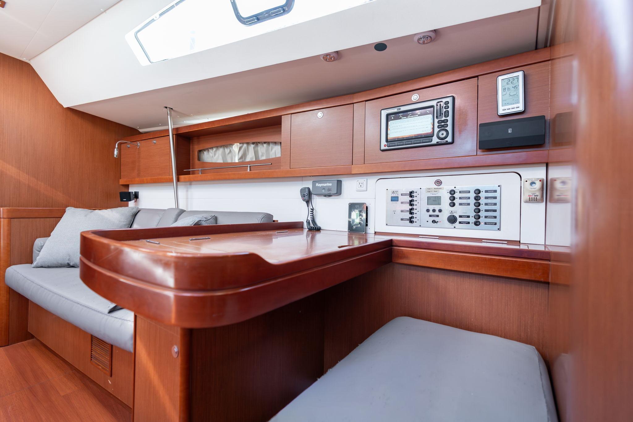 Interior of 2013 Beneteau Oceanis 50 yacht with navigation station and seating area.