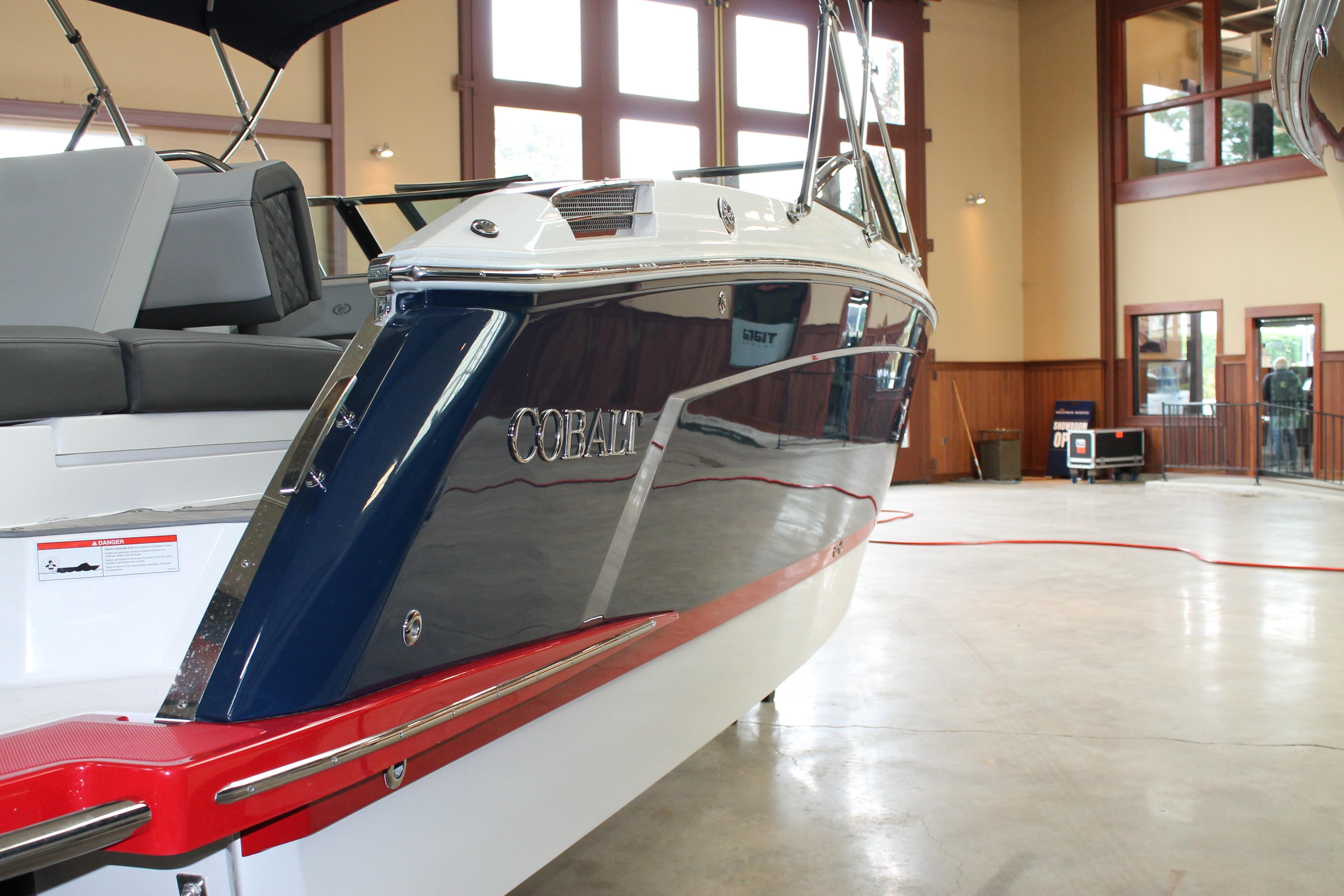 2023 Cobalt R8 boat in showroom, showcasing sleek design and luxurious seating.