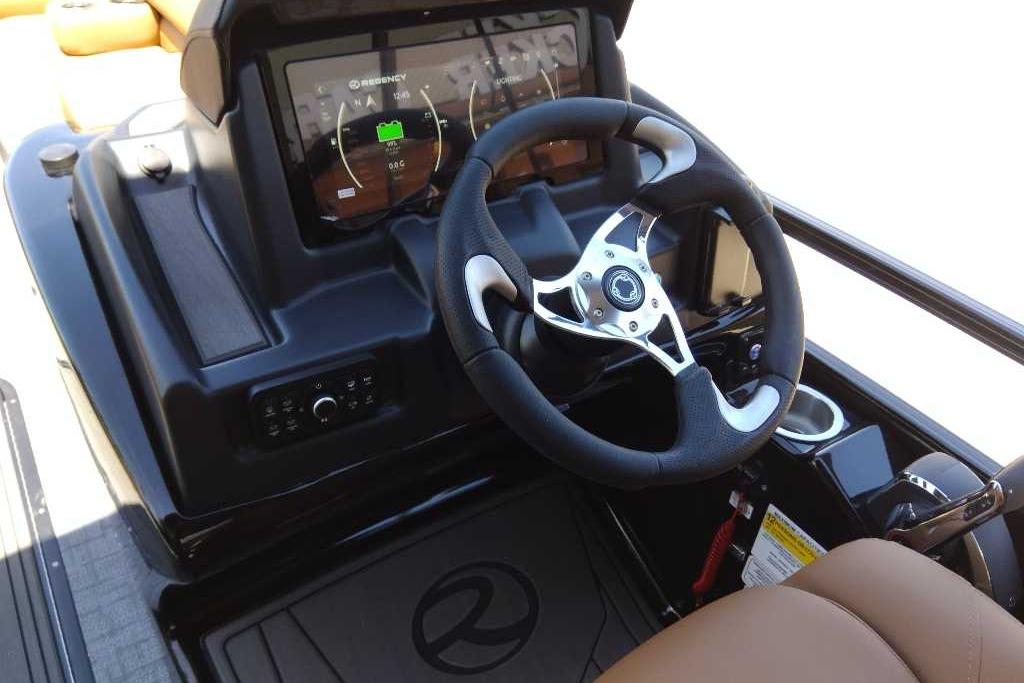 Steering console of 2026 Regency 230 DL boat with modern dashboard and controls.