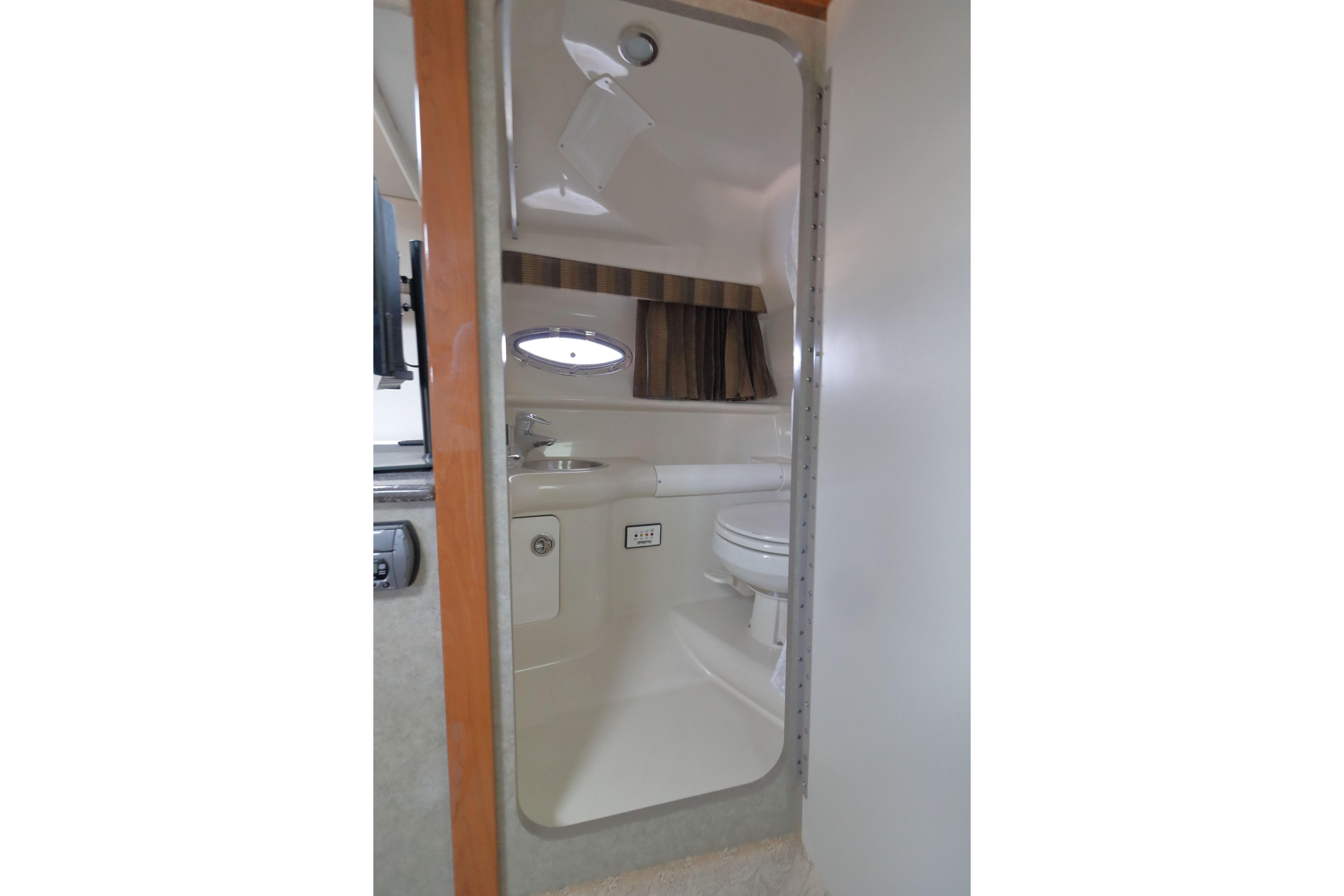 Interior view of 2006 Formula 330 Sun Sport boat bathroom with sink and toilet.