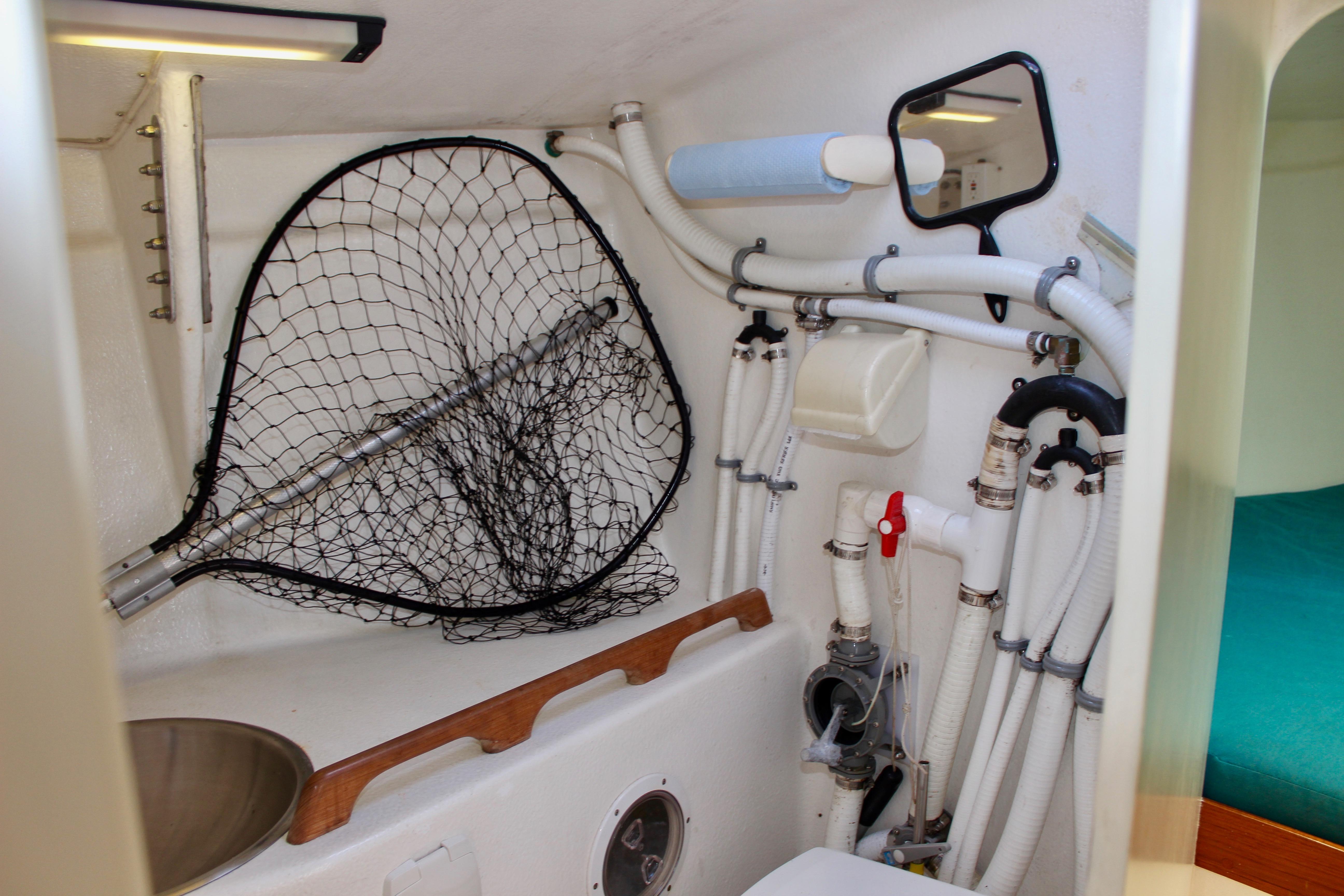Interior of 1993 Freya 39 boat showing plumbing, net, and sink.