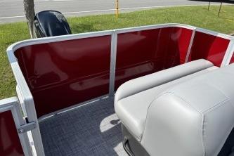 2026 Sun Tracker Party Barge 18 DLX with red paneling and gray seating.