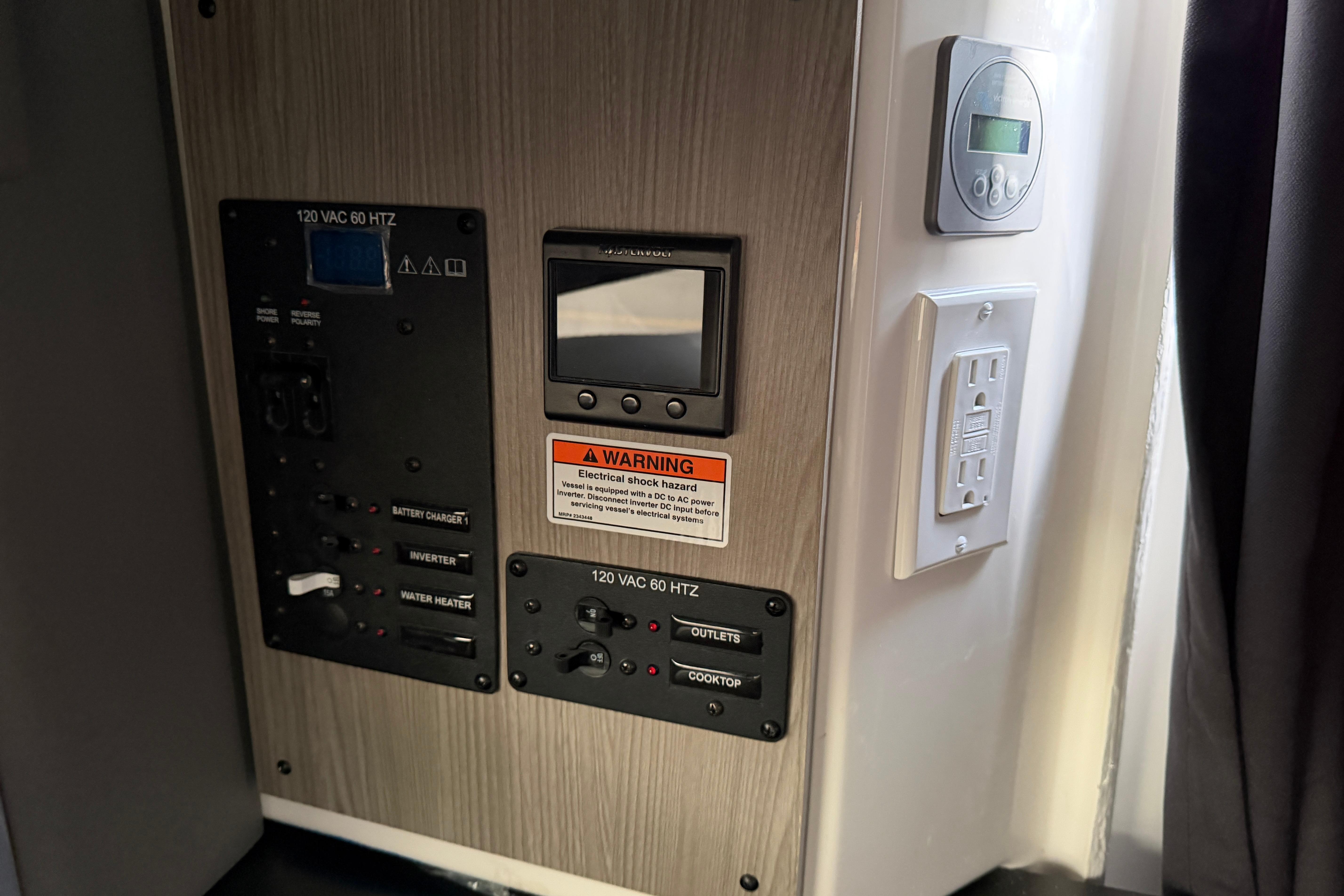 Control panel of 2026 Navan C30 with electrical outlets and warning label.