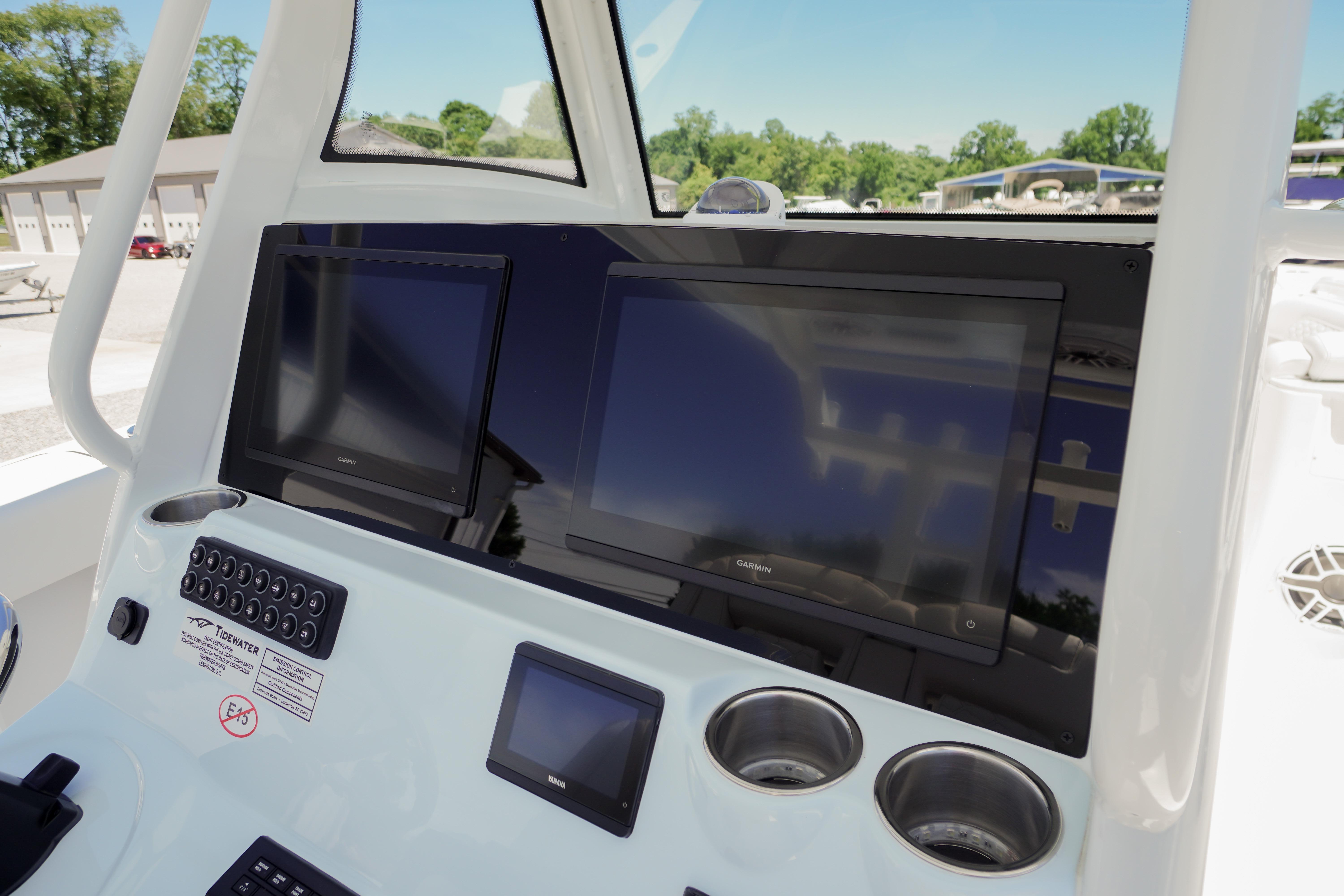 Dashboard of 2026 Tidewater 302 CC Adventure boat with modern navigation screens.