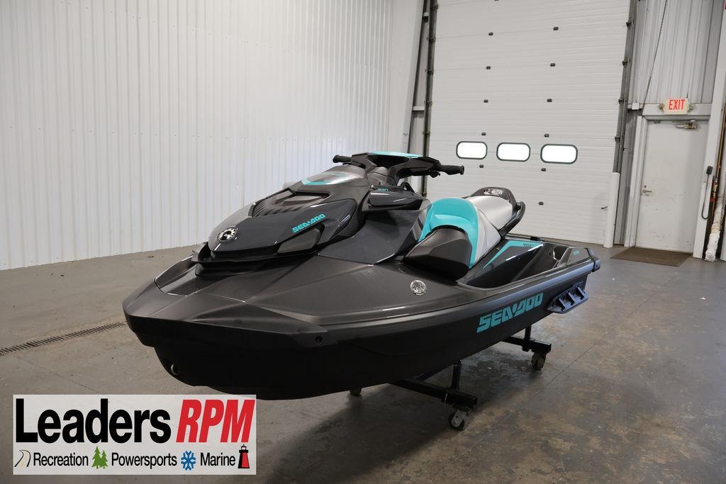 2026 Sea-Doo GTR 230 jet ski in showroom, featuring sleek black and teal design.