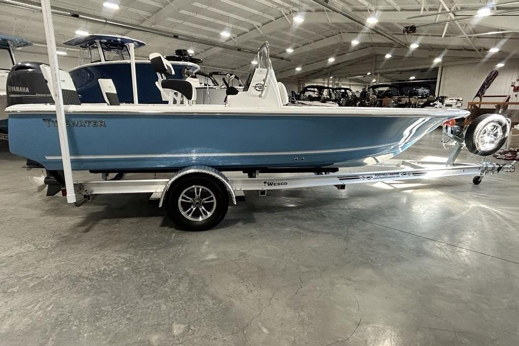 2026 Tidewater 1910 Bay Max boat on trailer in showroom setting.