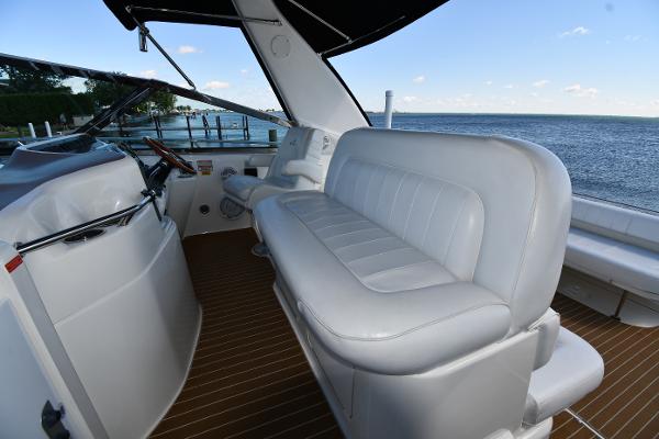 1997 Sea Ray 400 Sundancer cockpit with white seating, overlooking serene ocean view.