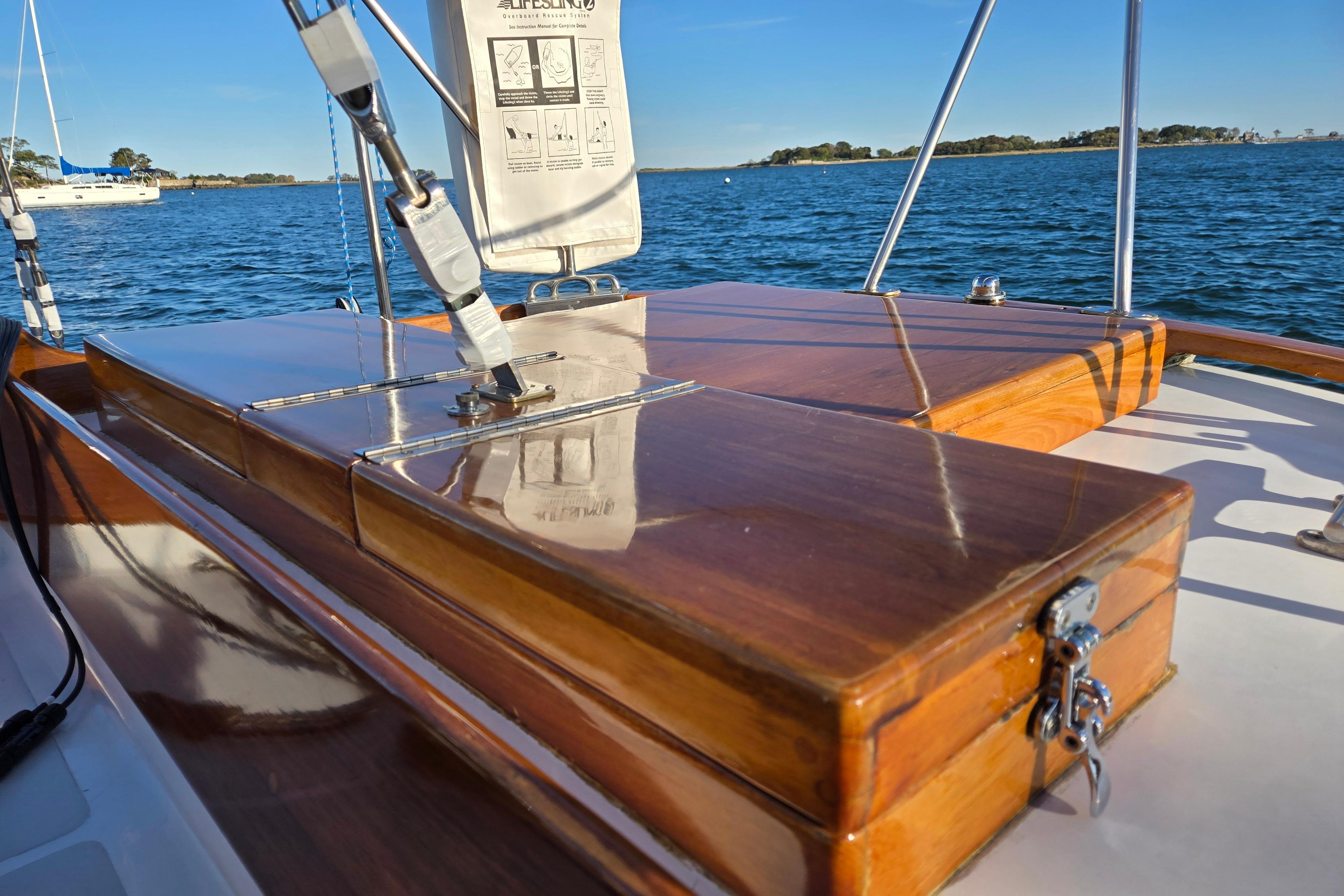 Hinckley Bermuda 40 sailboat, 1970 model, featuring polished wooden deck details on a sunny day.