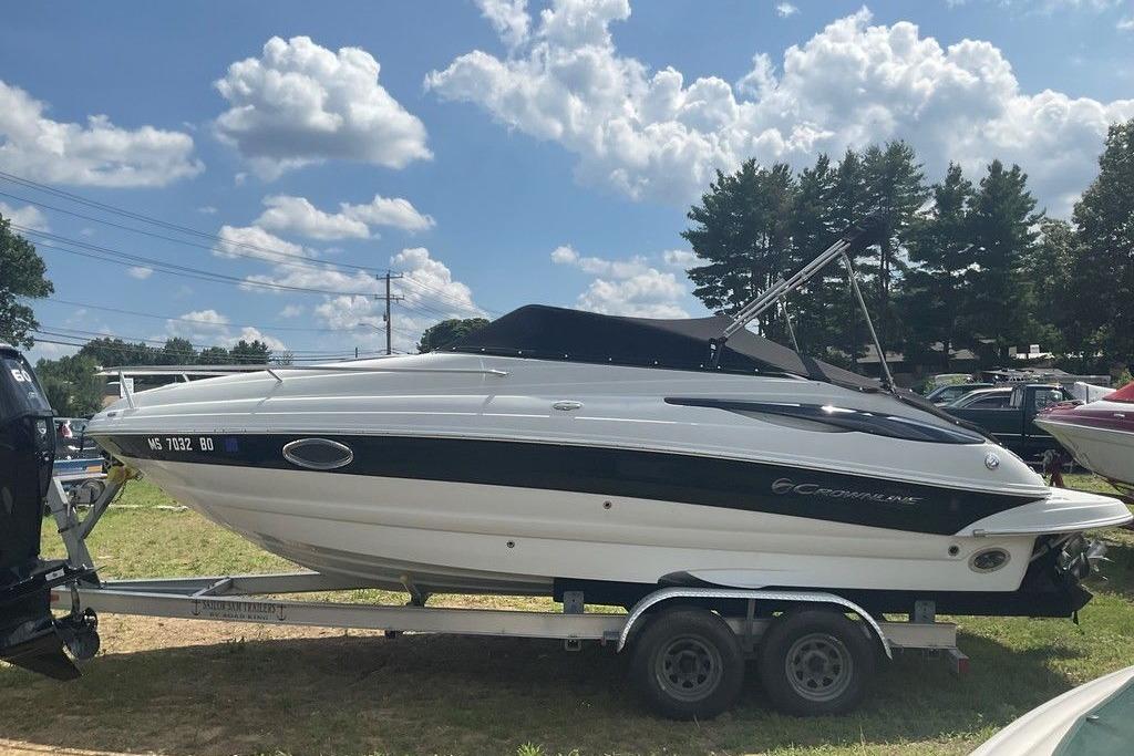 2015 Crownline 236 SC boat on trailer under a partly cloudy sky.