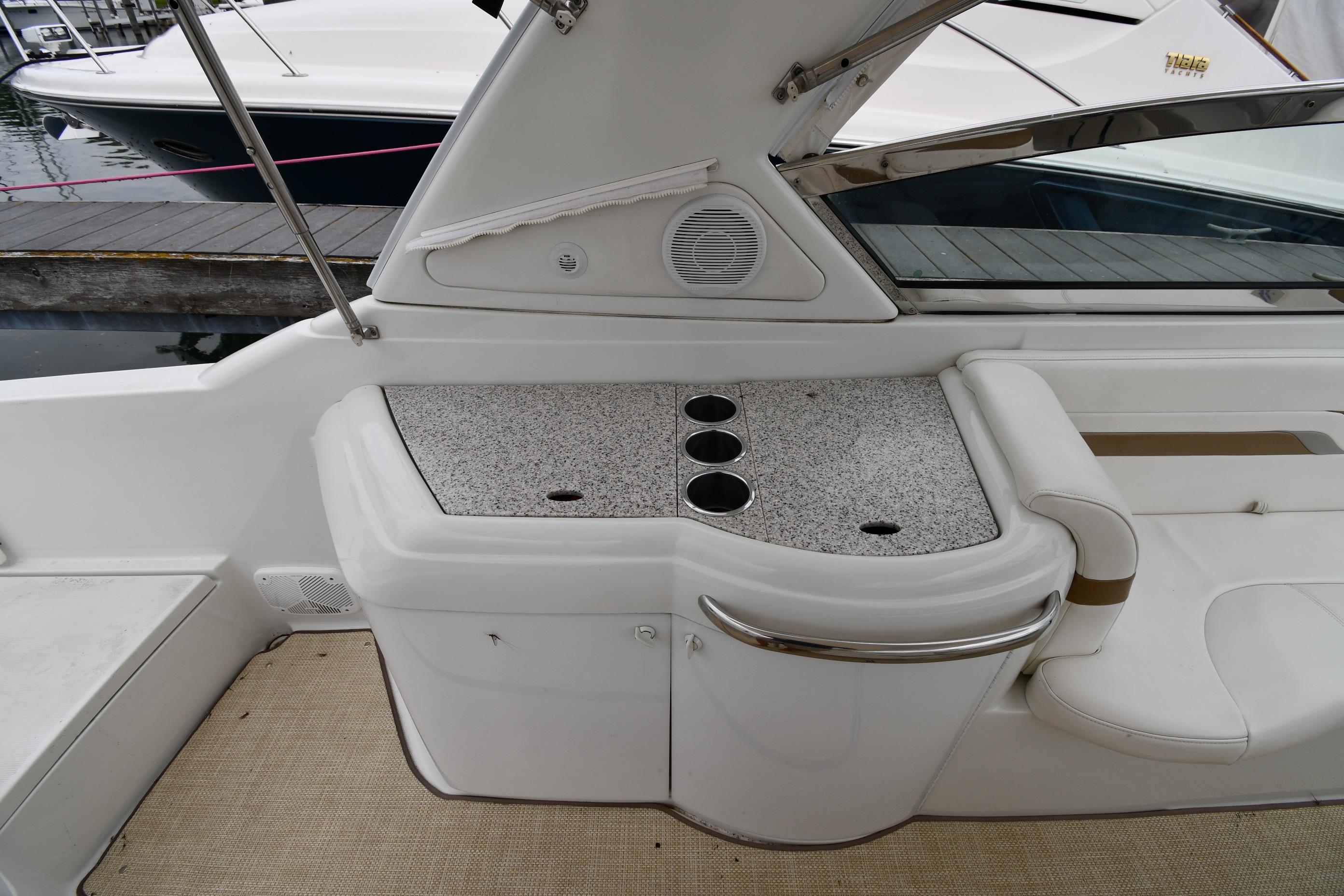 2004 Formula 330 Sun Sport boat interior with cup holders and seating area.