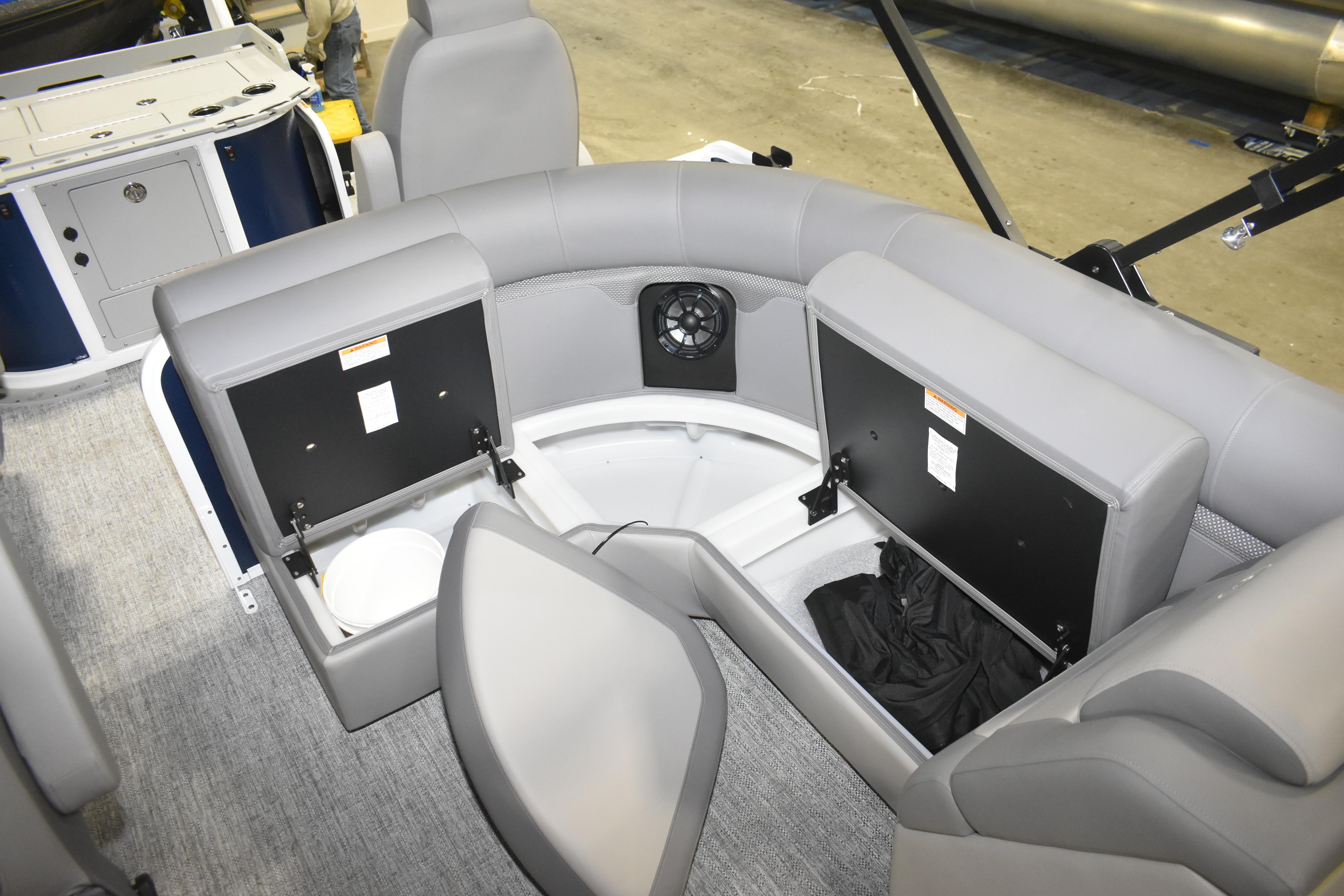Interior of 2026 Premier 230 Sunsation Angler 4PT boat with storage compartments open.