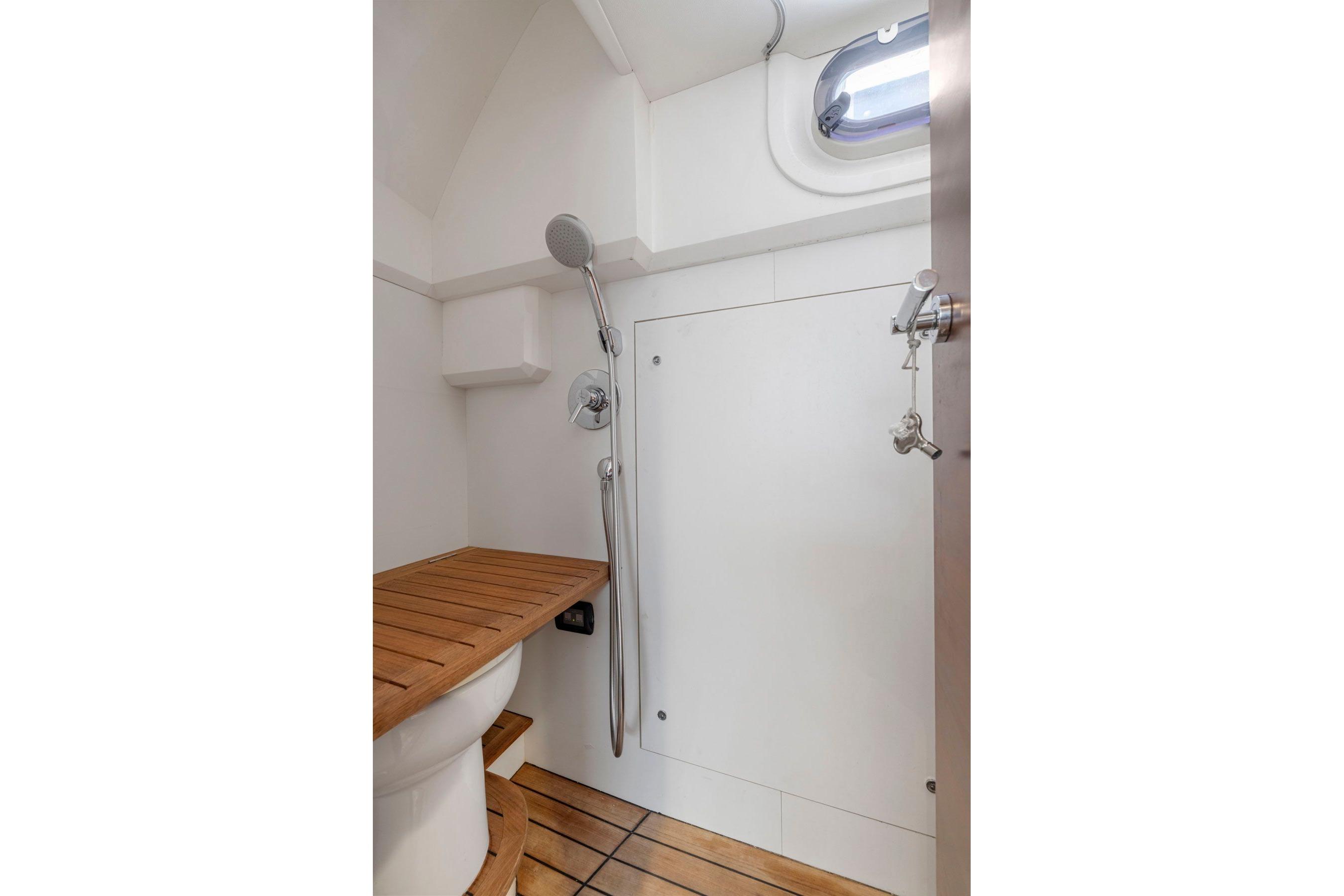Bathroom interior of 2015 Princess 60 Flybridge Motor Yacht with wooden accents and shower.