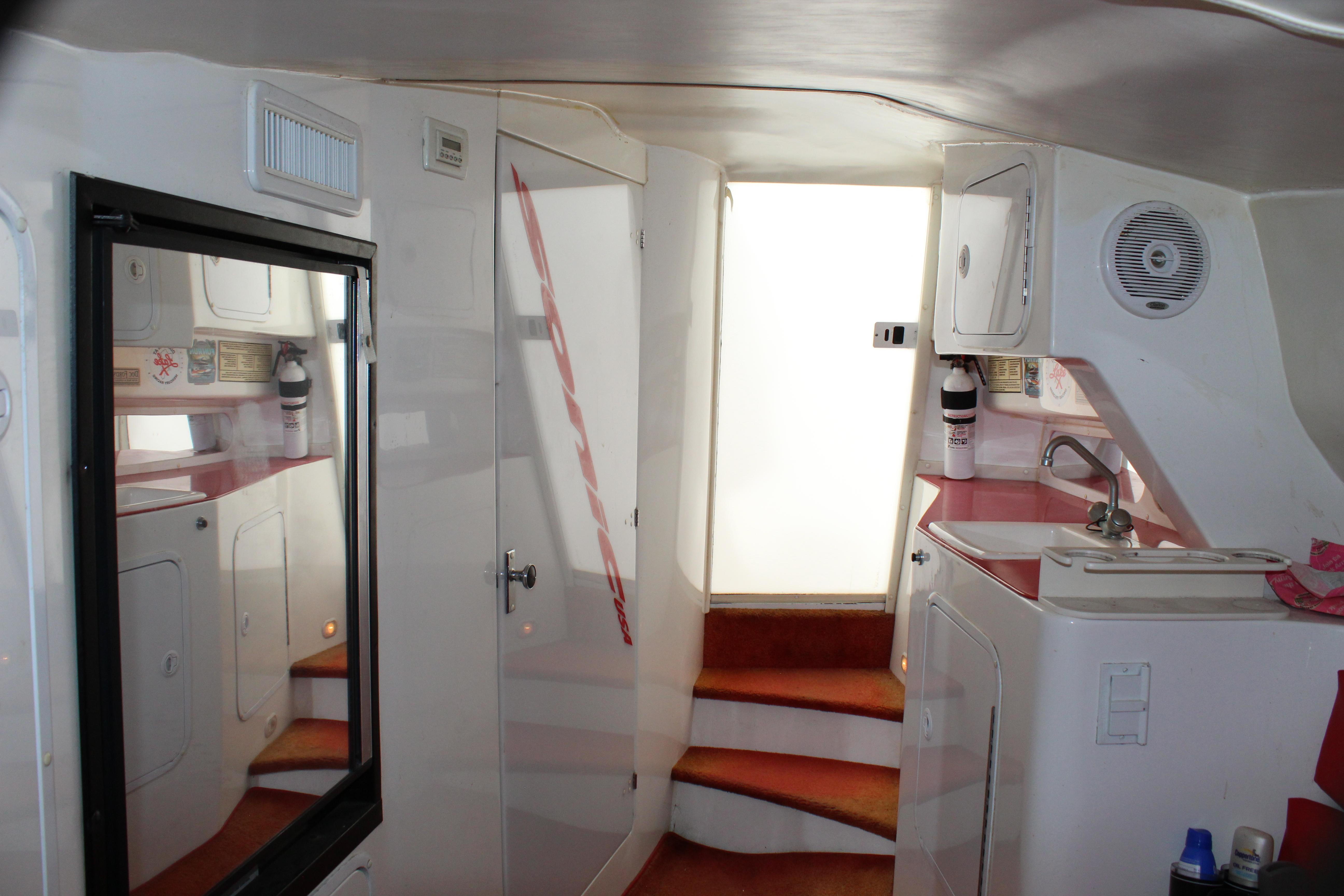Interior of 2001 Sonic 42 SS boat with compact kitchen and stairs.