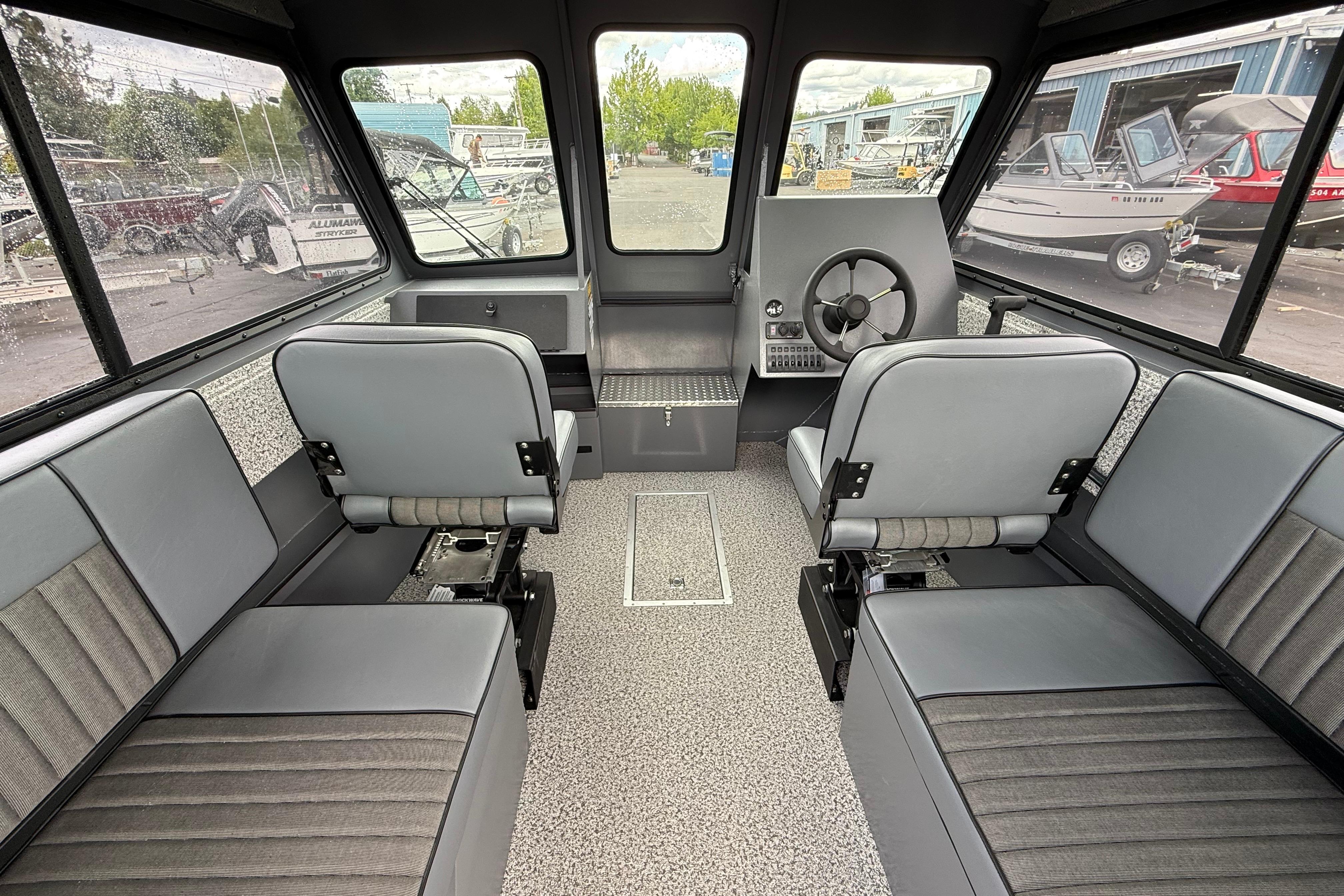 2026 Alumaweld Intruder 22 HT boat interior with gray seating and steering console.