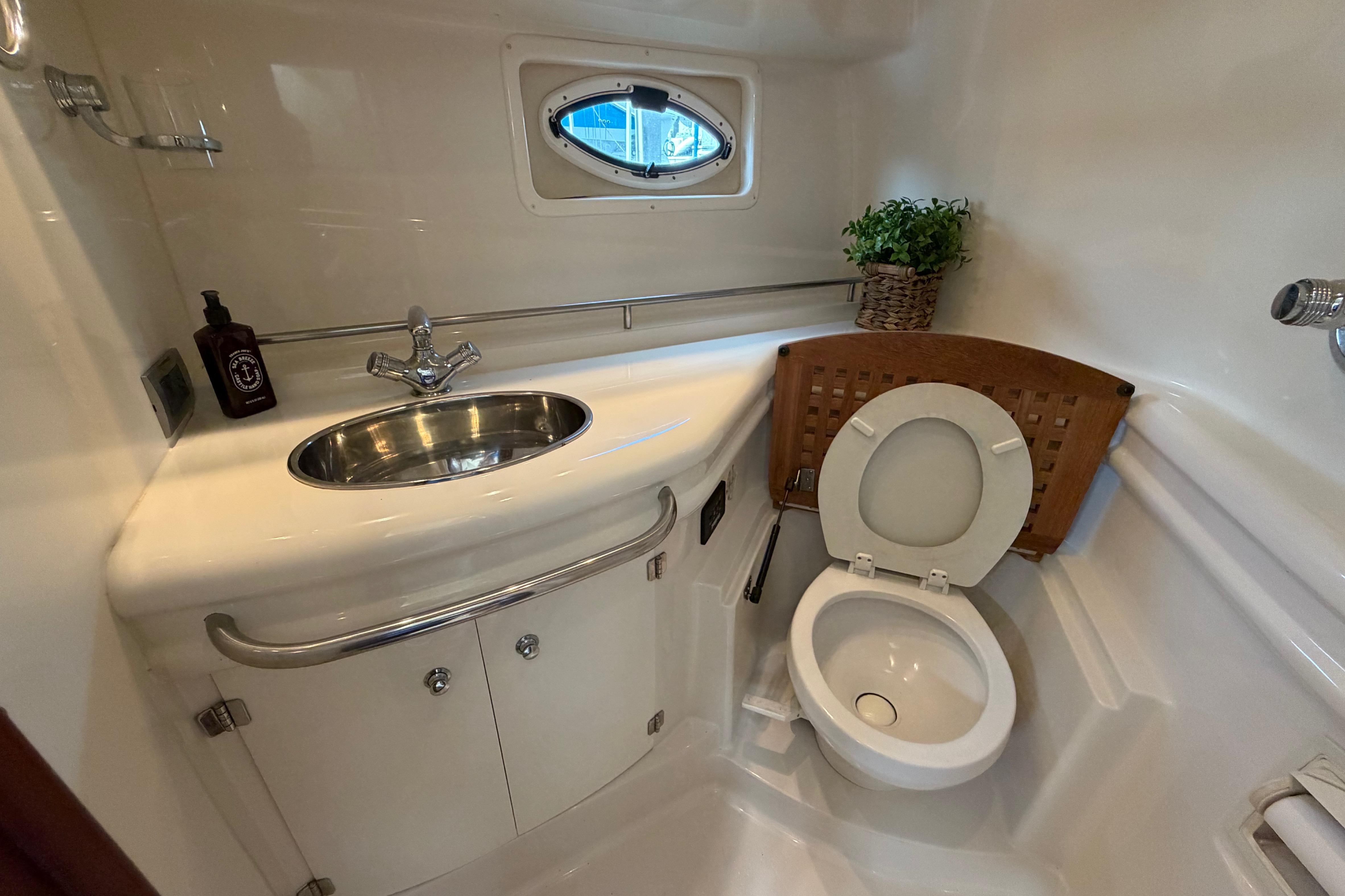 Bathroom interior of 2007 Monterey 350 Sport Yacht with sink and toilet.