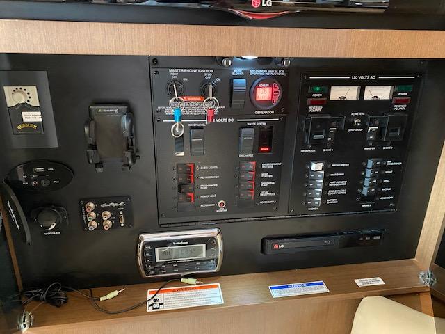 Control panel of a 2015 Sea Ray 350 Sundancer boat with various switches and gauges.