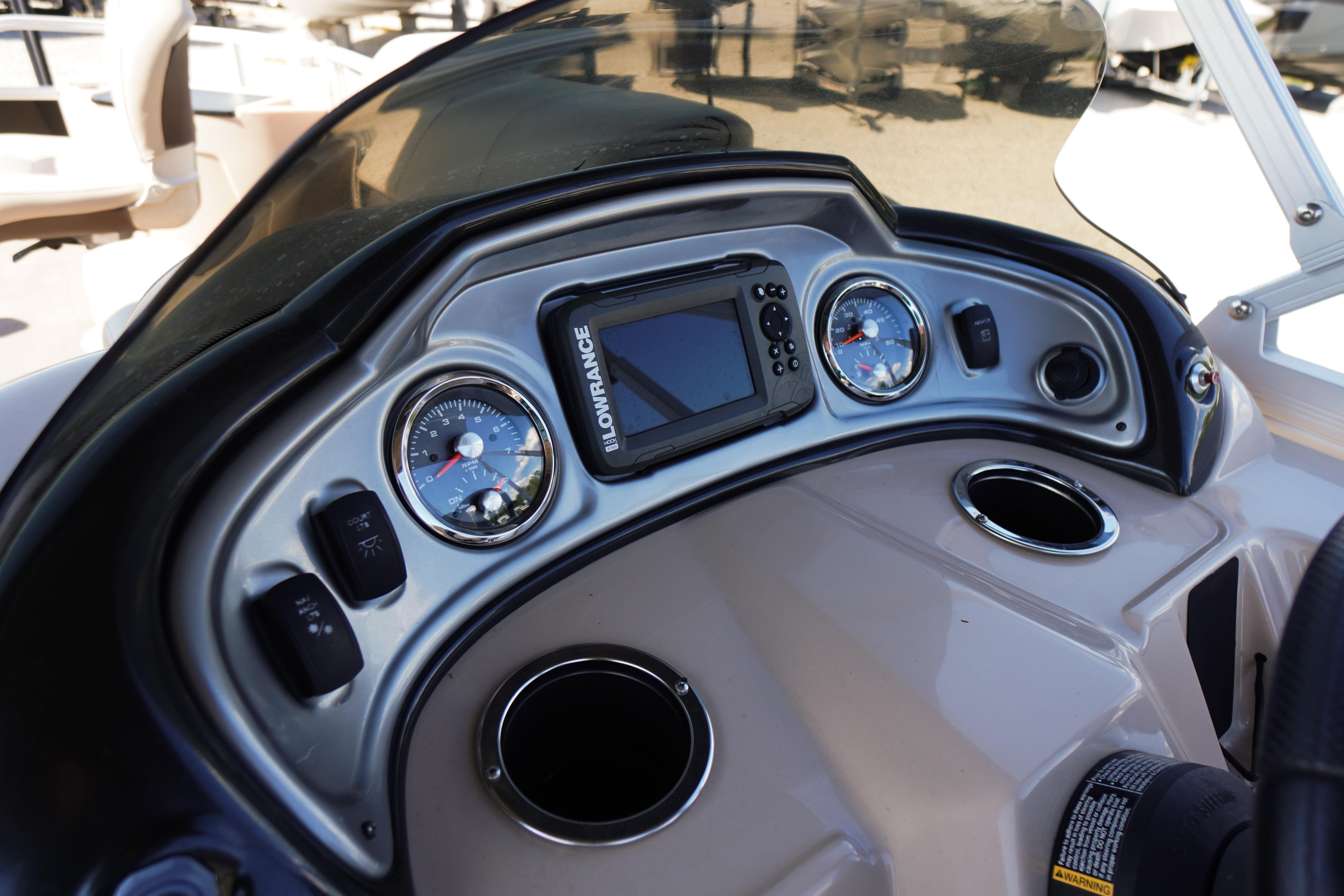 Dashboard of 2019 SUNTRACKER Fishin' Barge 22 DLX with gauges and Lowrance display.