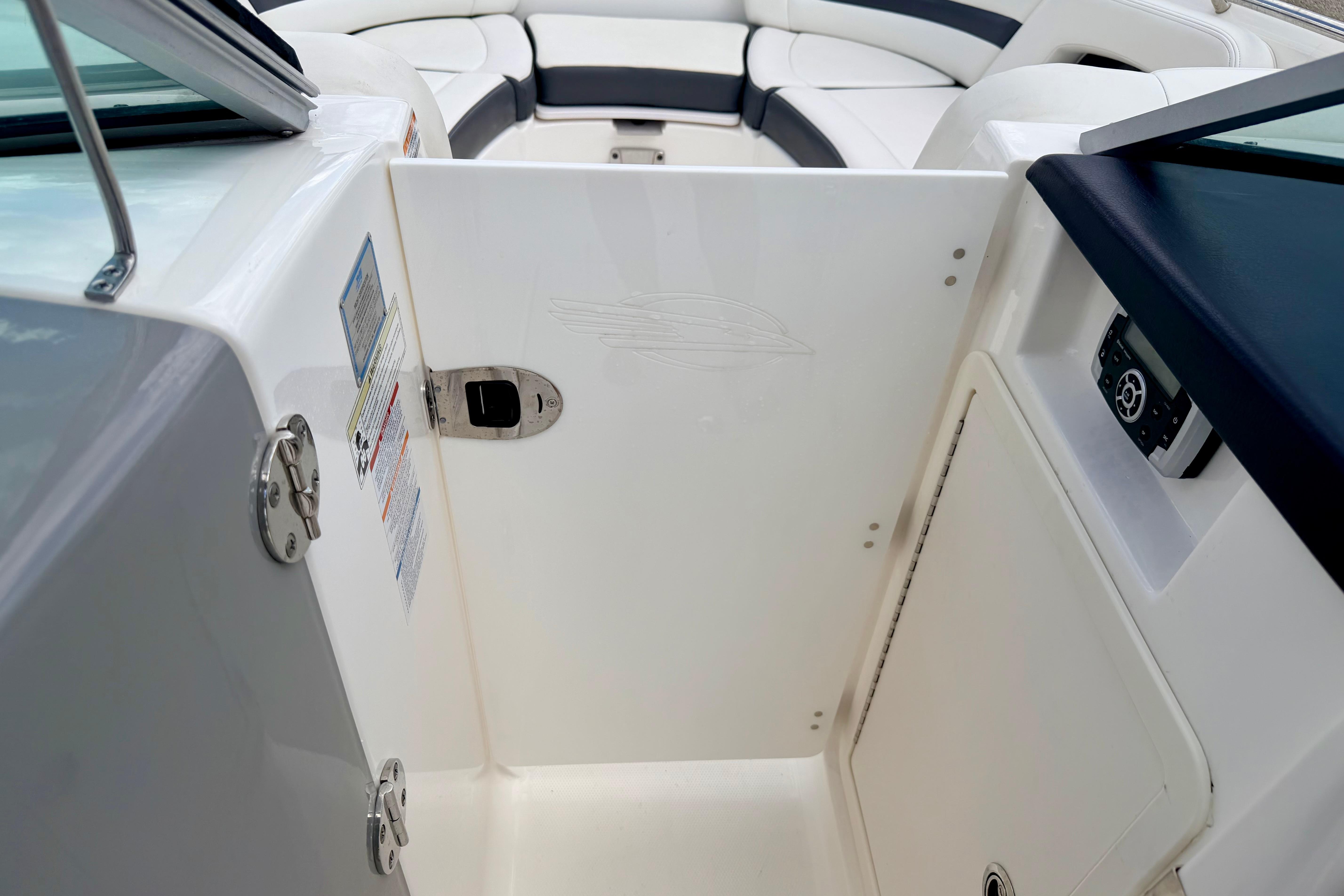 2015 Chaparral Sunesta 264 boat interior with seating and control panel.