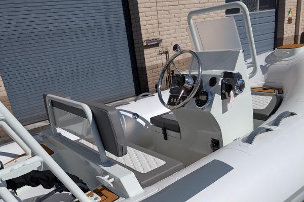 2025 Tide Craft San Juan 11 boat interior with steering wheel and seating.