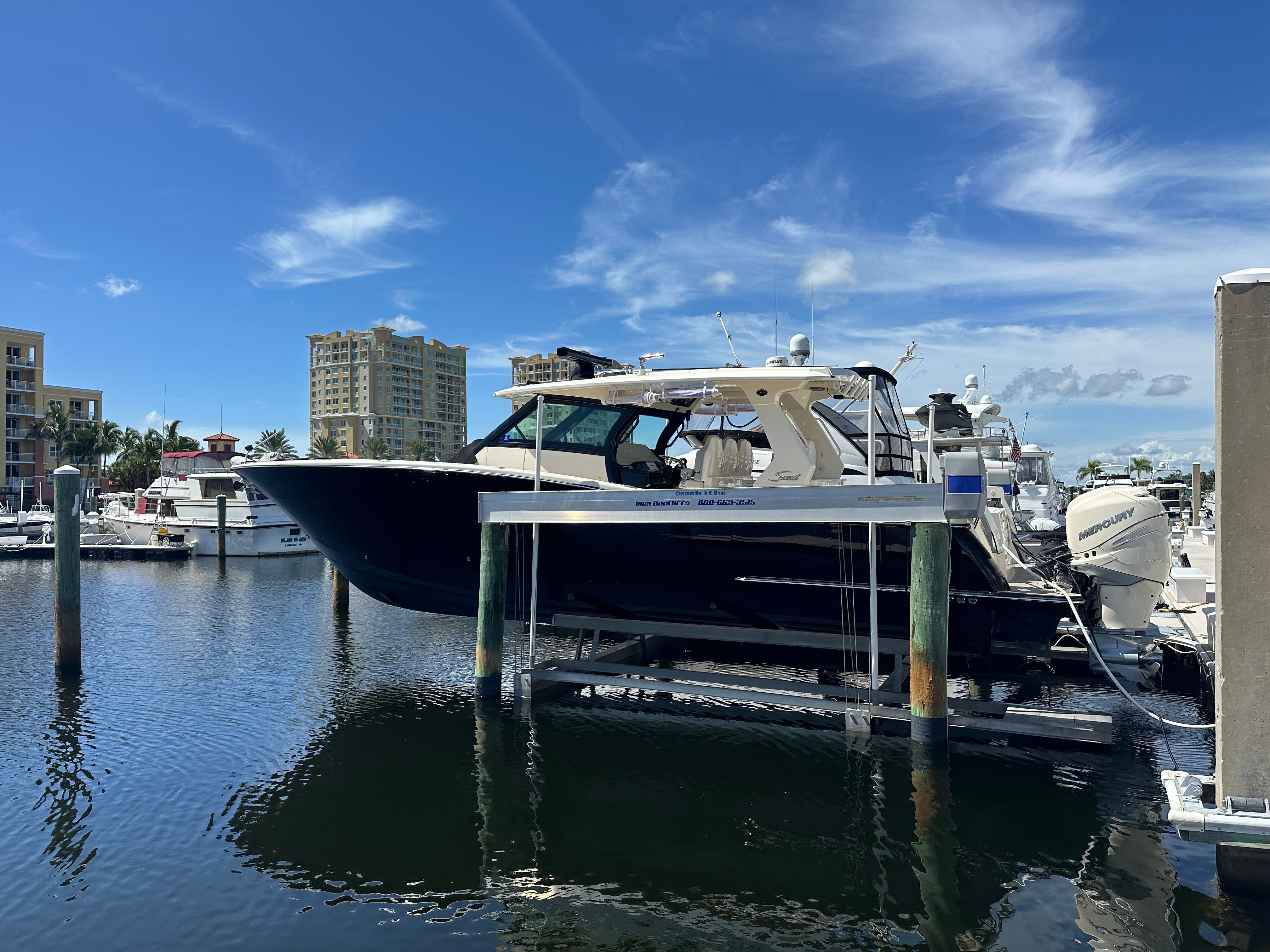 Scout 425 LXF 2022 on a boat lift at the marina.