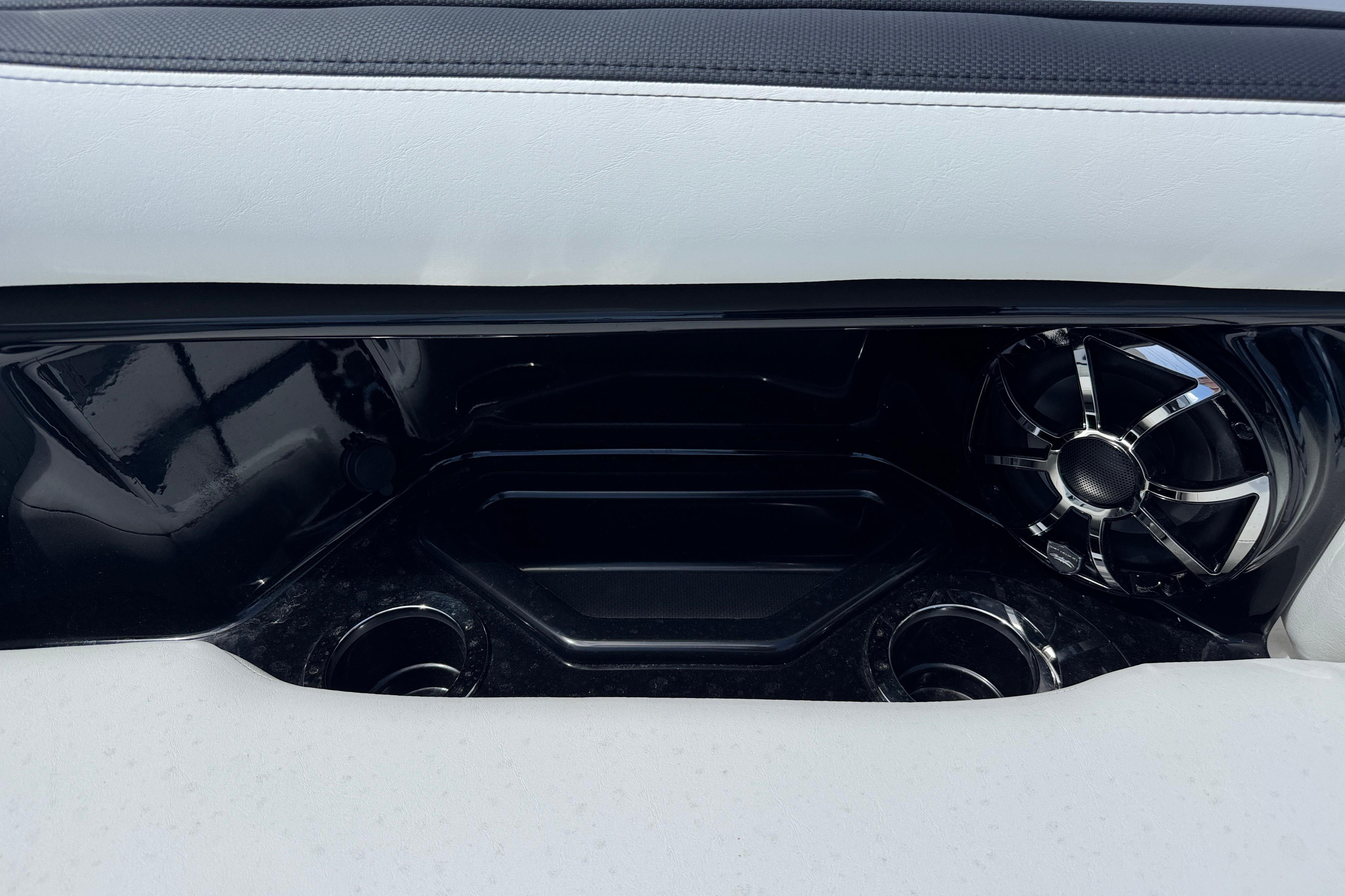 Interior detail of 2026 Yamaha Boats 275SD, featuring sleek speaker and cup holders.