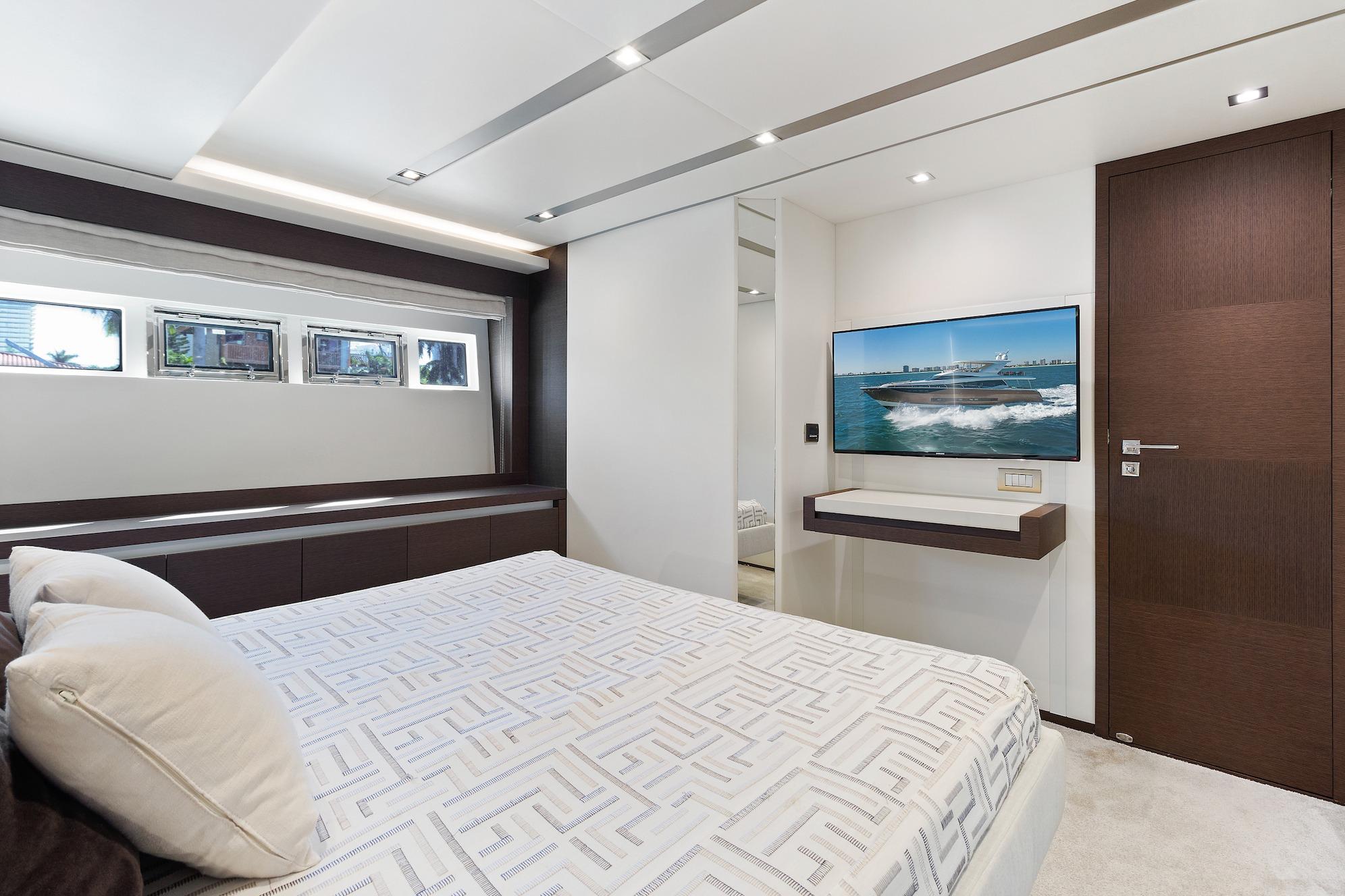 Luxurious bedroom interior on a 2015 Prestige 750 yacht, featuring modern design and elegant decor.