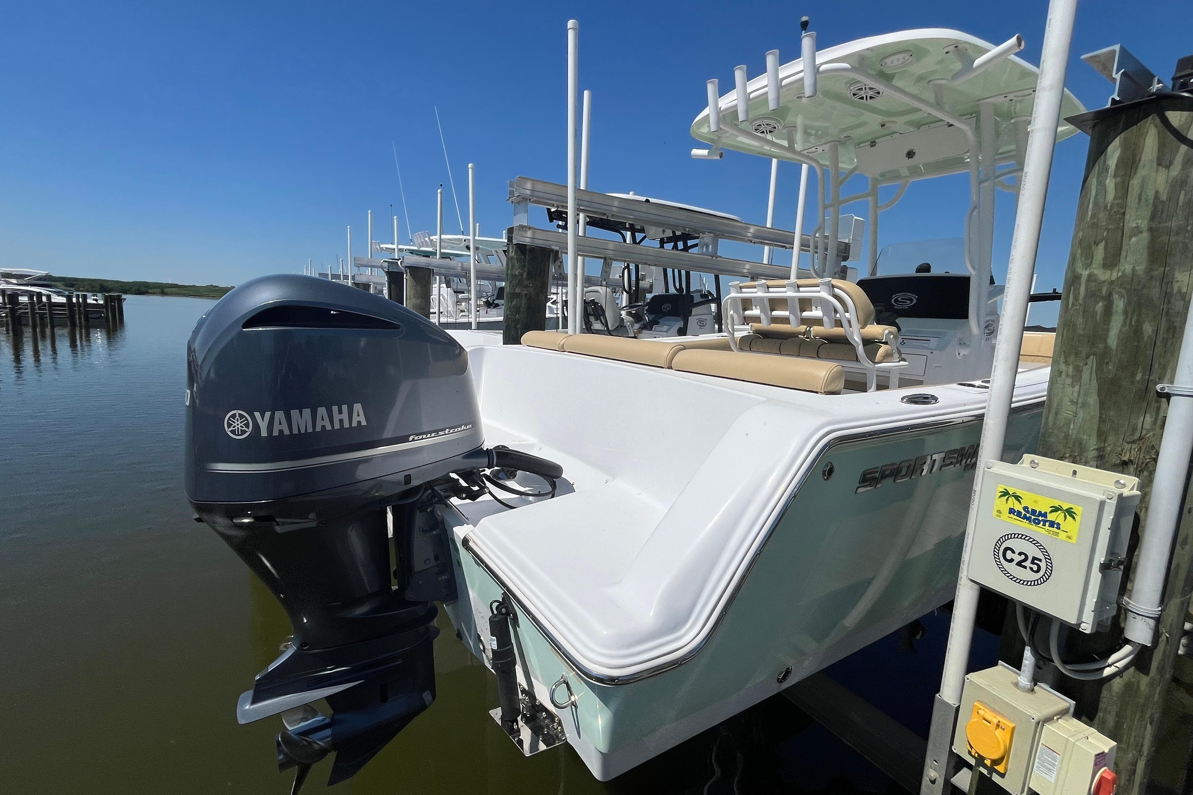 2021 Sportsman Heritage 231 Center Console boat with Yamaha engine docked at marina.