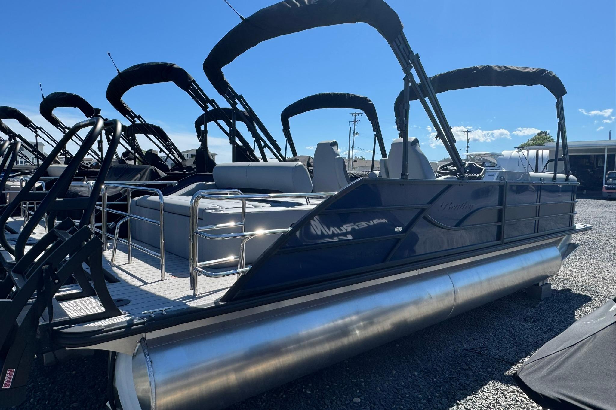 2026 Bentley Pontoons Legacy 243 Swingback, sleek design, docked under clear blue sky.