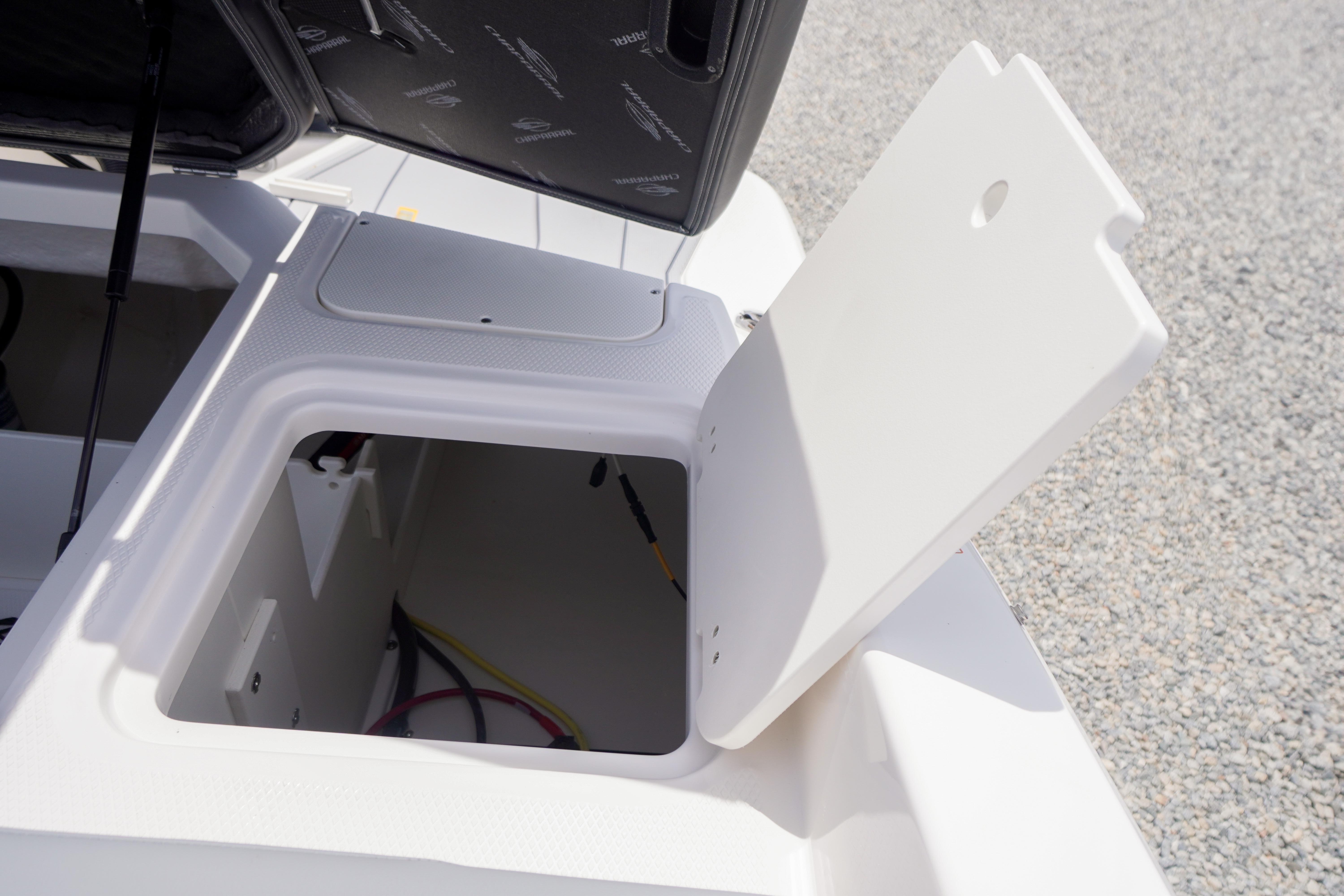 Open storage compartment on 2026 Chaparral 23 SSi OB boat.