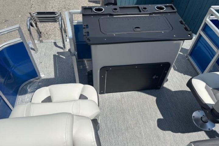 2026 Sun Tracker Fishin' Barge 20 DLX interior with seating and control panel.