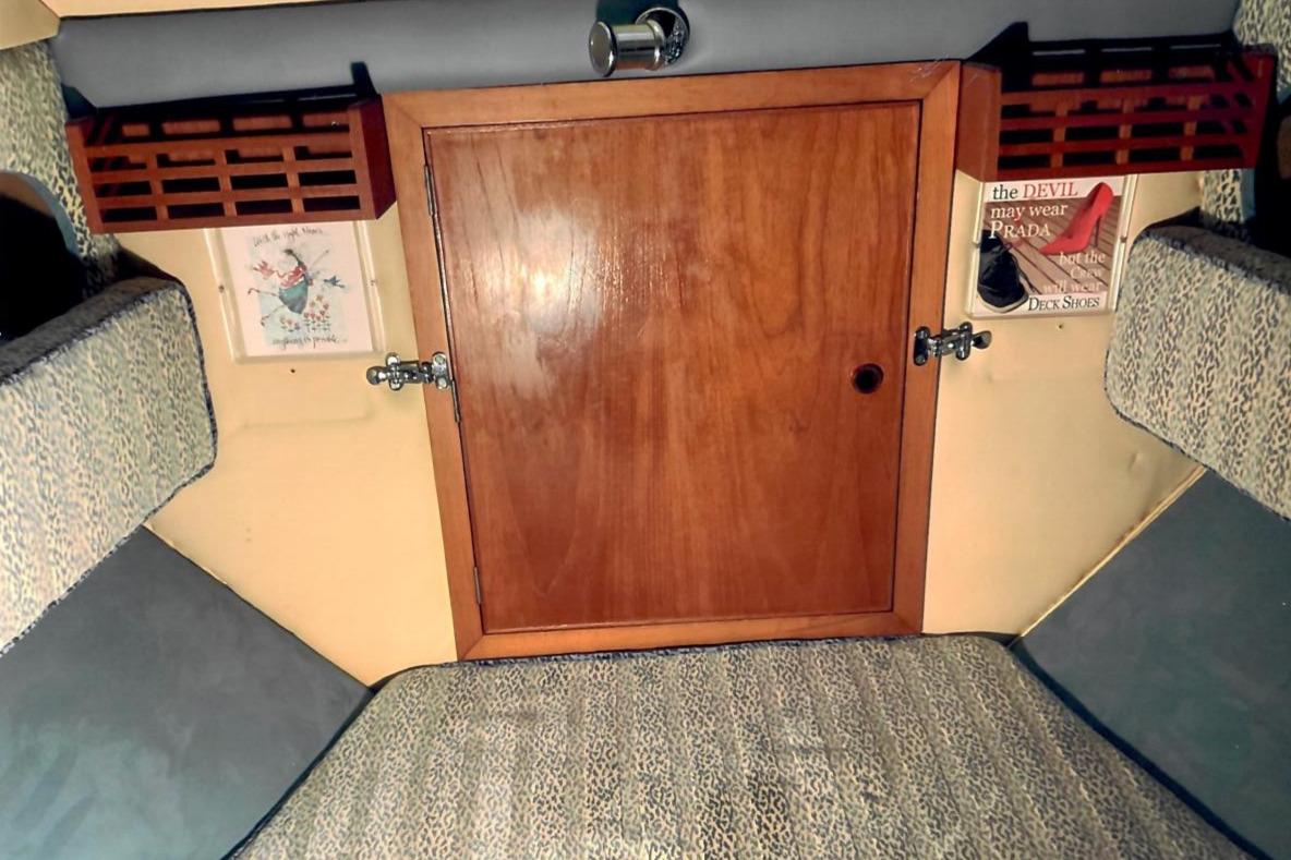 Interior of 1989 Fairey Spearfish MKIII with wooden cabinet and patterned upholstery.