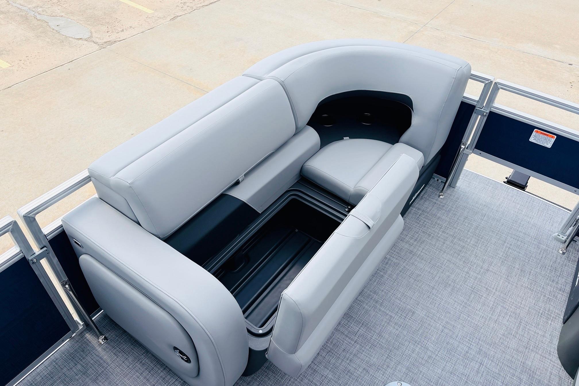 2026 Sun Tracker SportFish 22 DLX pontoon boat with spacious gray seating and storage compartment.