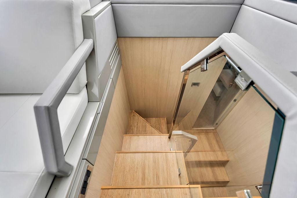 Staircase with glass railing on 2012 Fairline Targa 58 yacht interior.