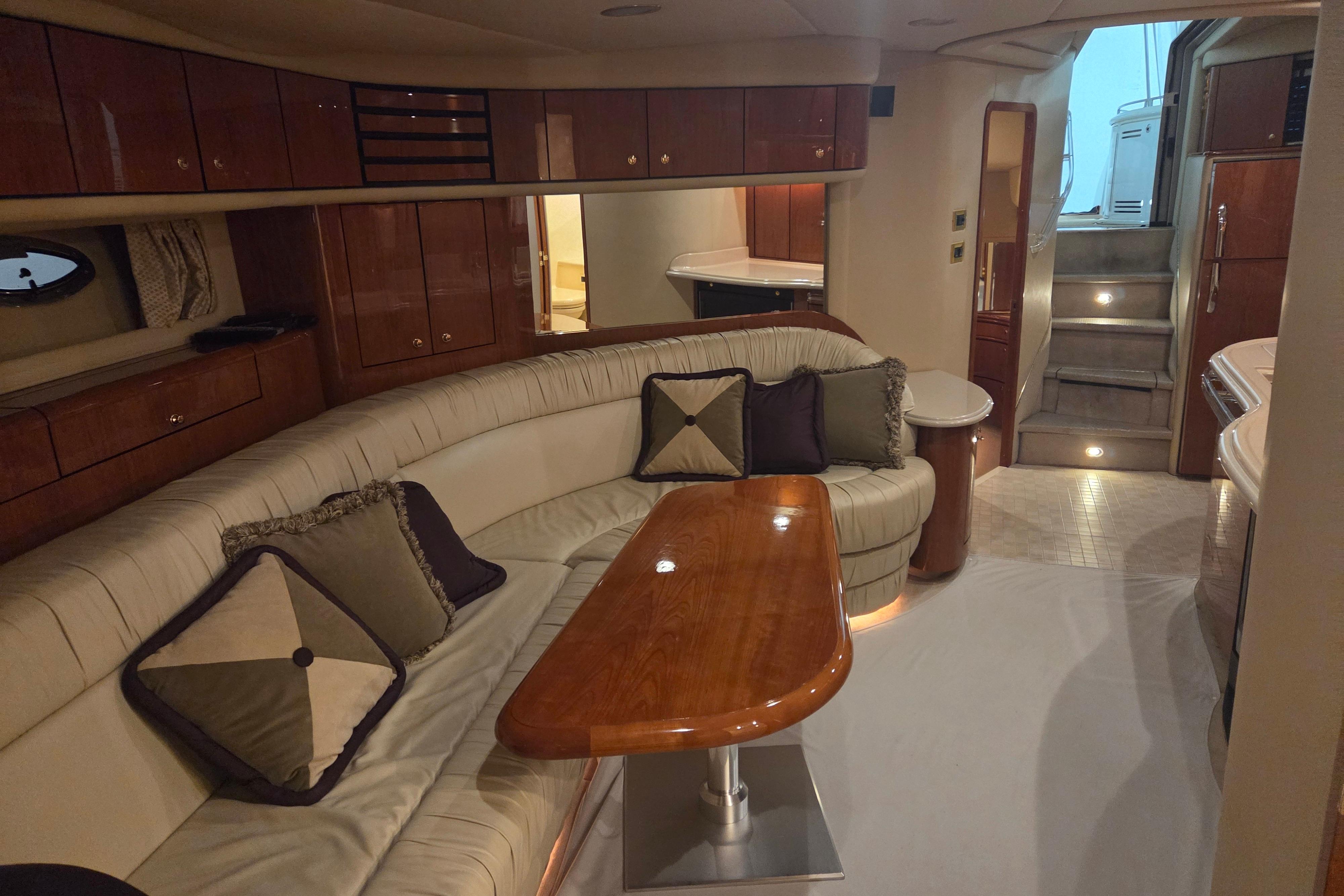 Luxurious interior of a 2000 Sea Ray Sundancer 540 yacht with elegant seating and wooden accents.