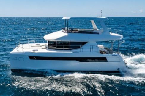 2024 Leopard 40 Powercat cruising on open sea under clear blue sky.