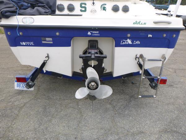 2007 Bayliner 197 Deck Boat rear view with propeller and ladder.
