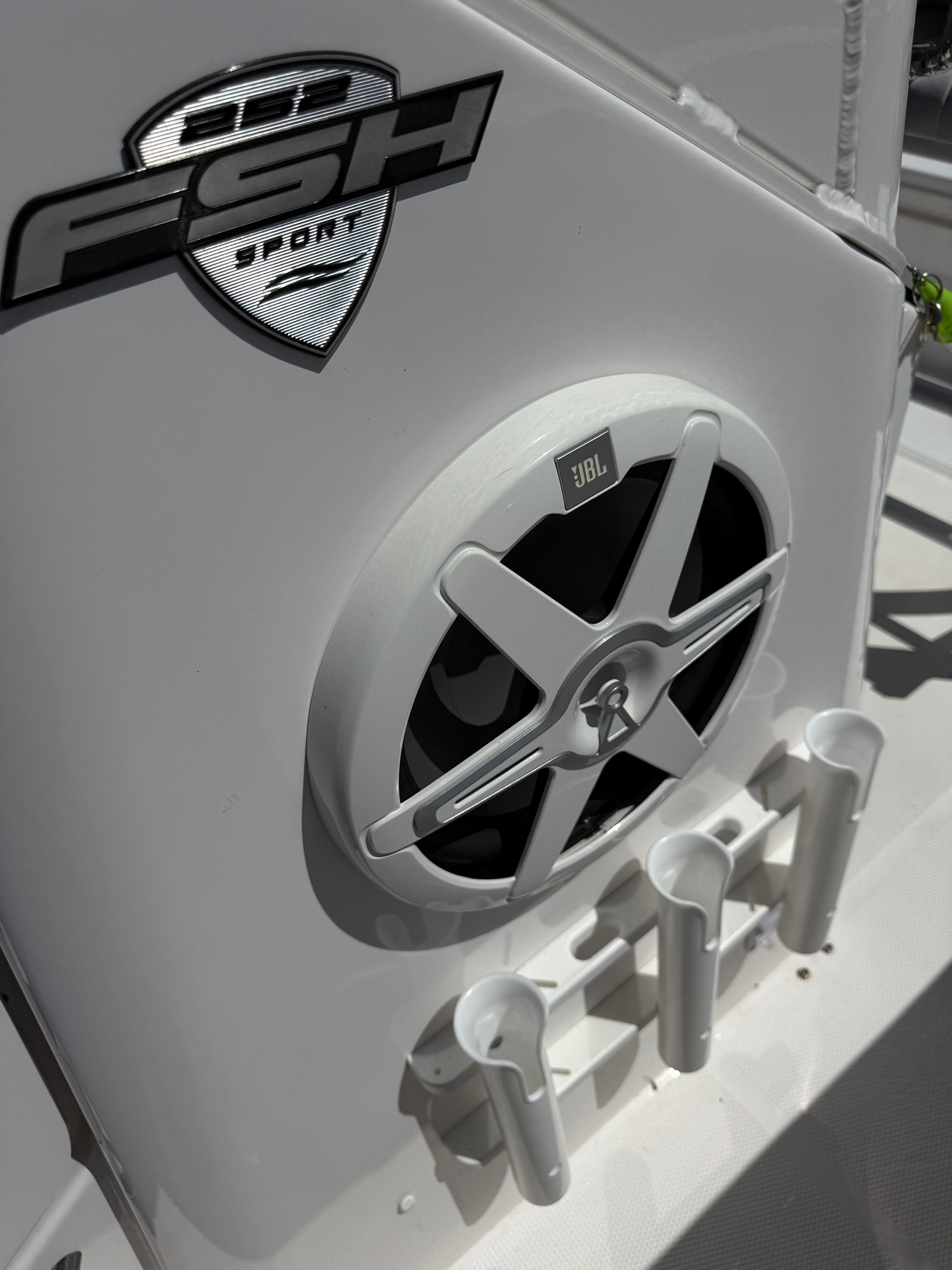 Close-up of a speaker and fishing rod holders on a Yamaha 252 FSH Sport boat.