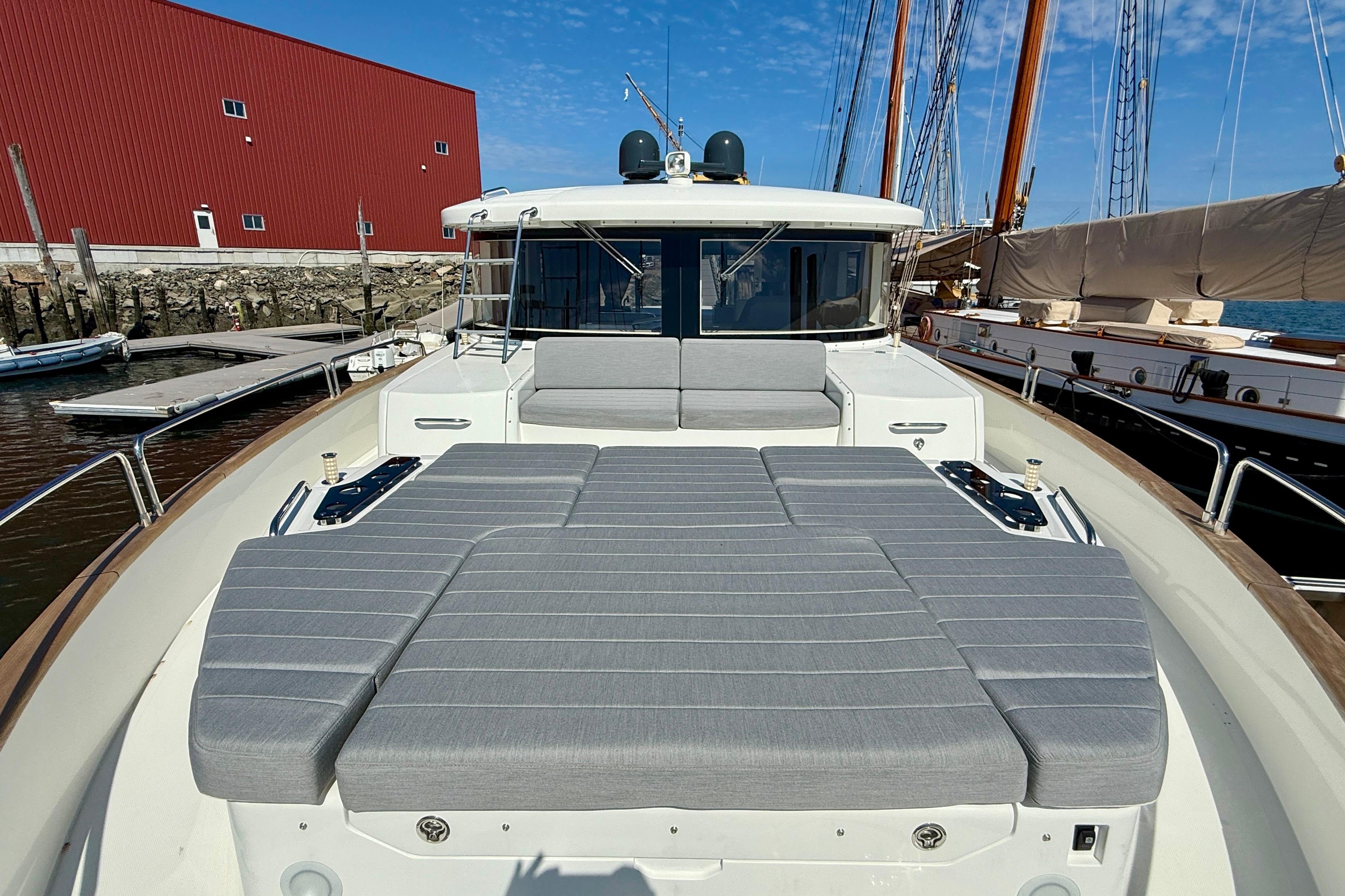 Luxury Sirena 58 yacht, 2022 model, featuring spacious deck with gray cushions.