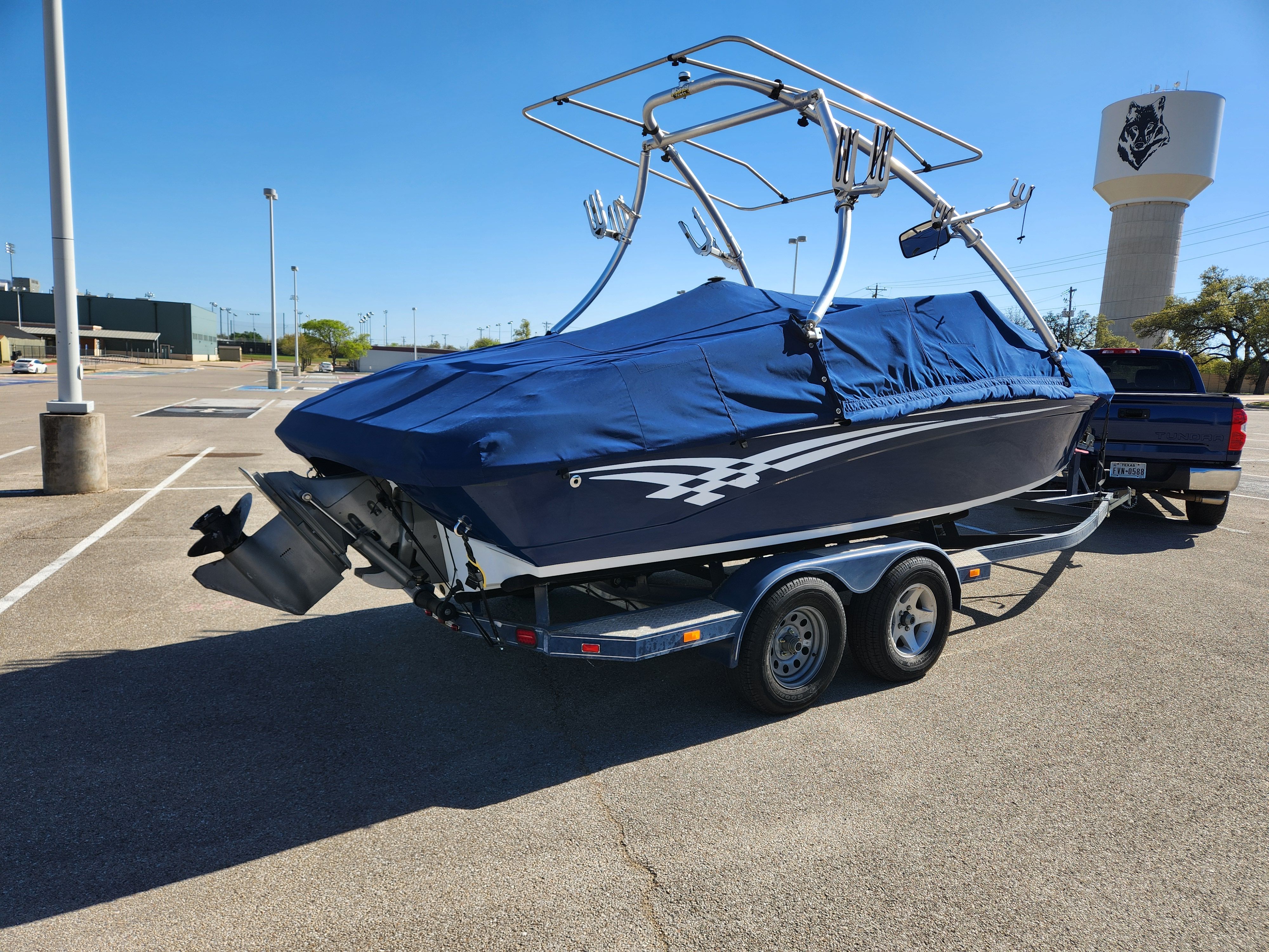 2003 Crownline 225 BR boat on trailer parked outdoors.