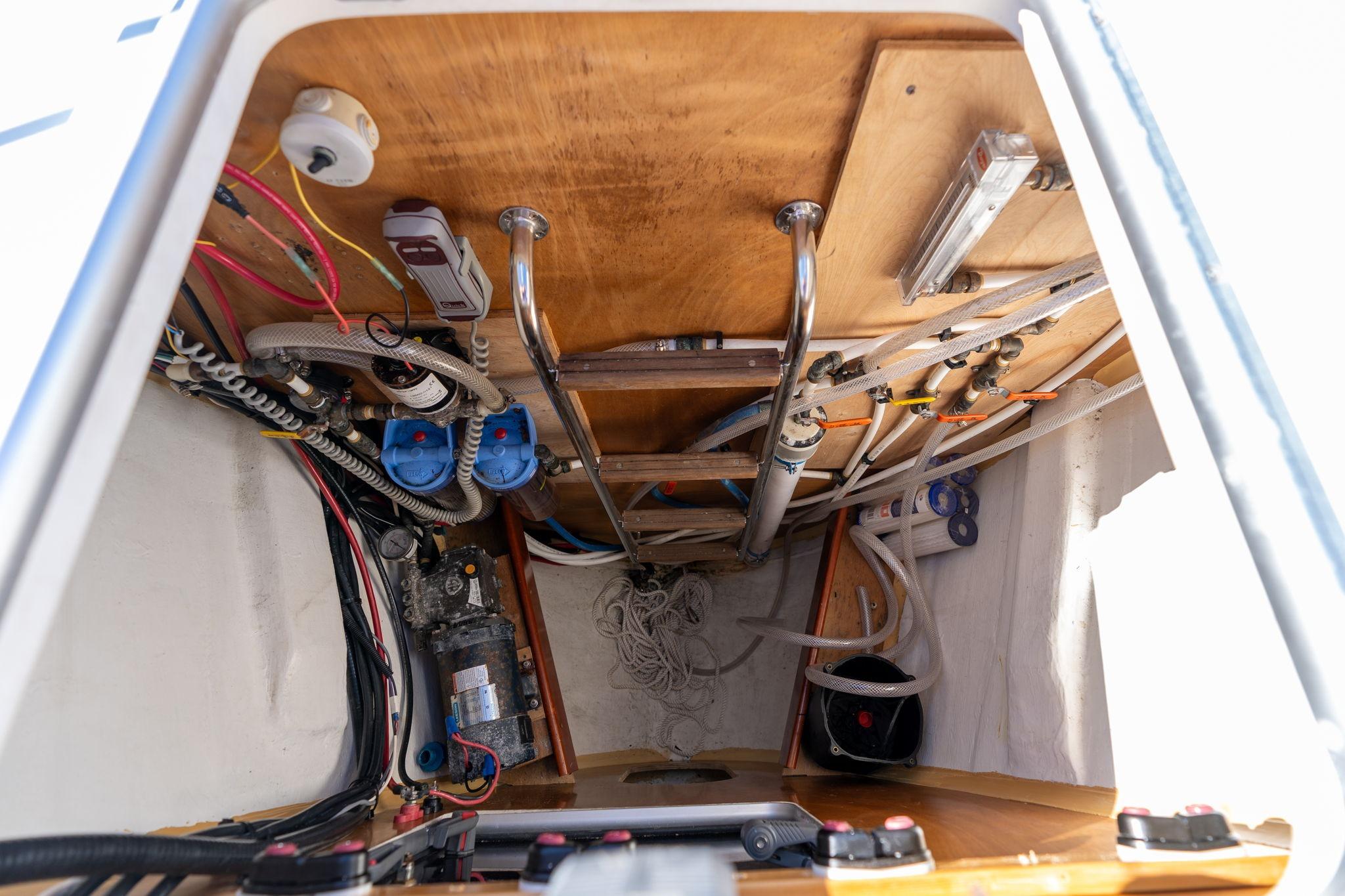 Engine compartment of 2013 Beneteau Oceanis 50 sailboat, showcasing wiring and mechanical components.