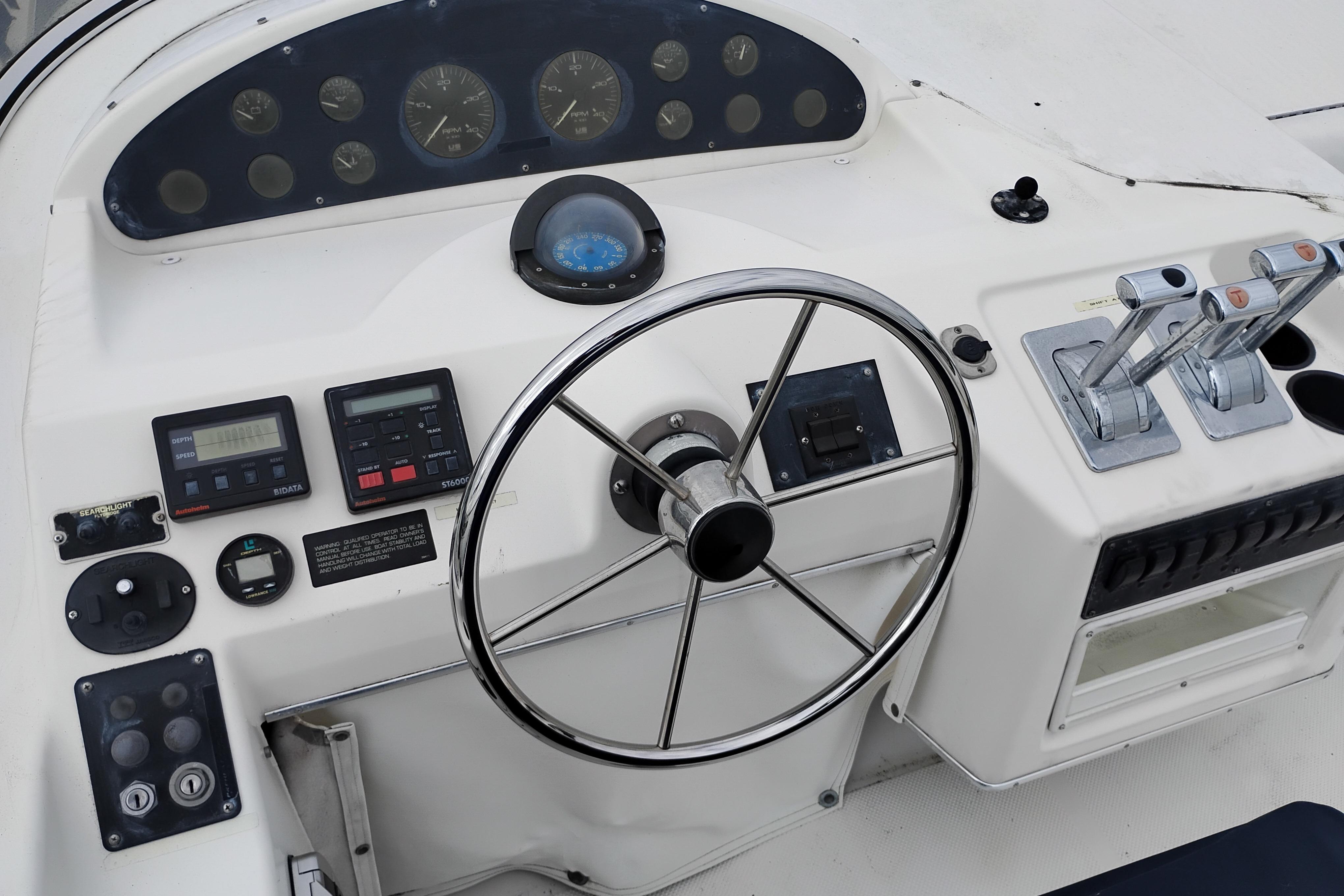 1995 Bayliner 3988 Motoryacht helm with steering wheel and control panel.