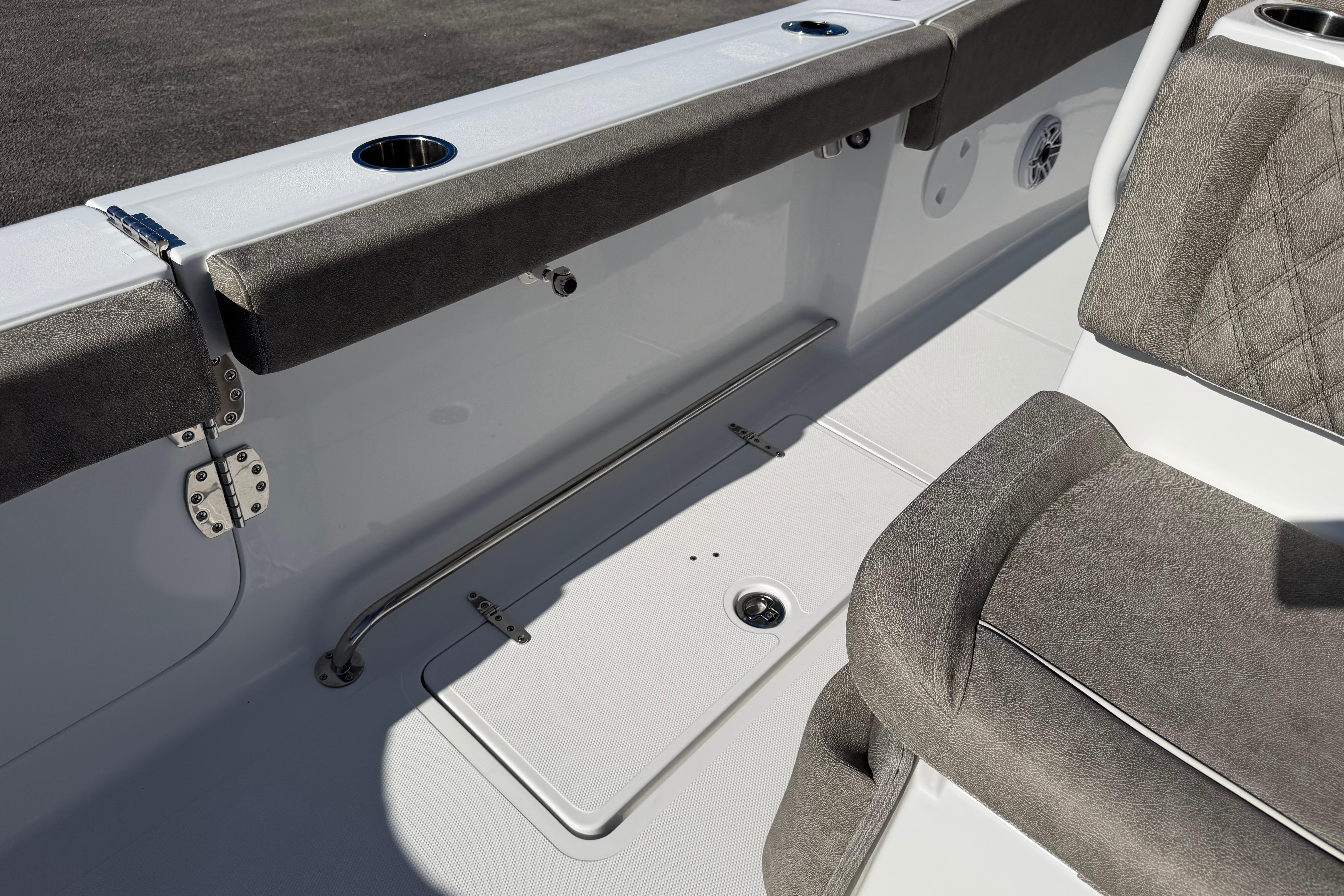 2026 Sea Hunt Ultra 275 Coffin Box boat interior with cushioned seating and stainless steel fixtures.