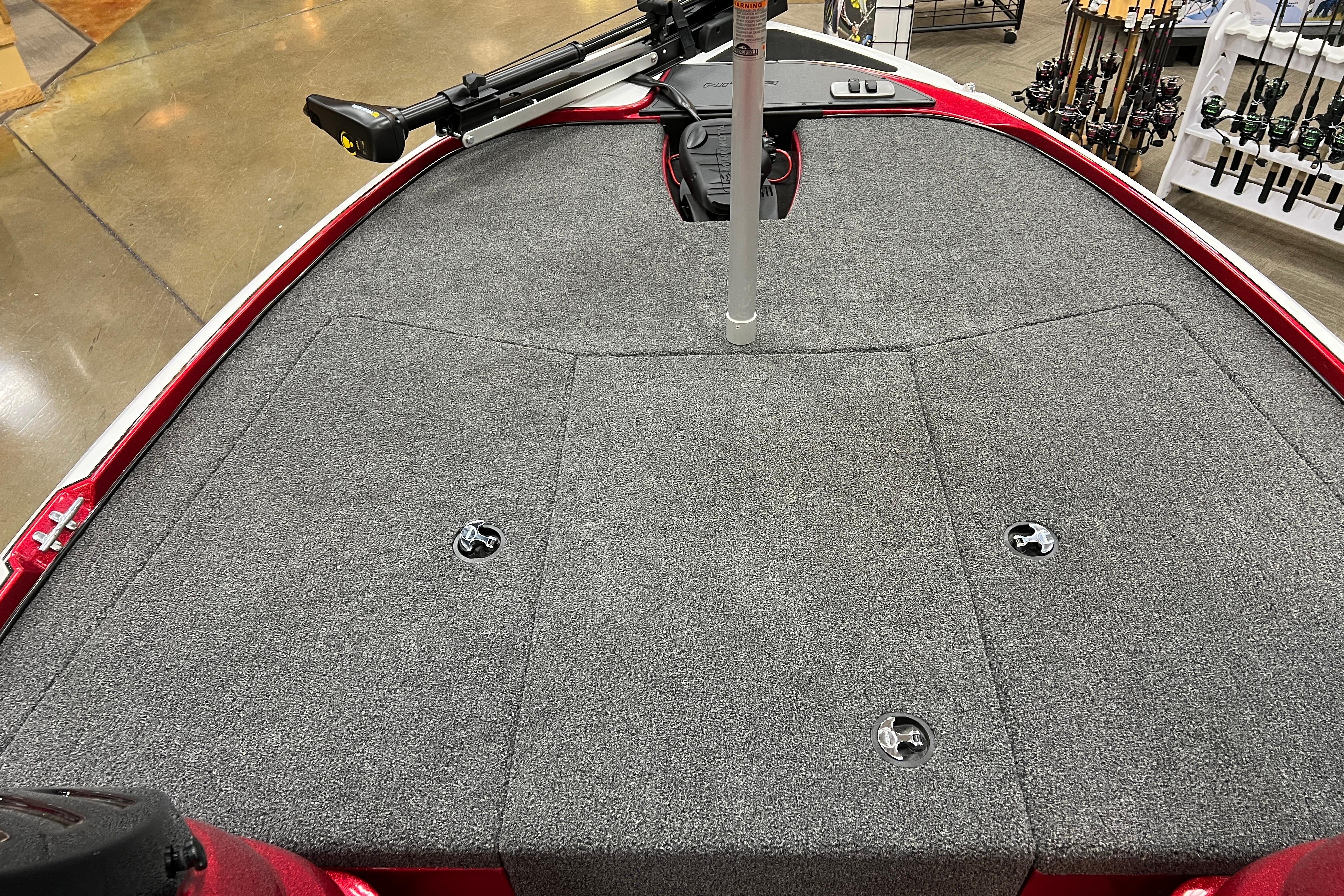 2026 Nitro Z17 boat deck with gray carpet and fishing rod holders.