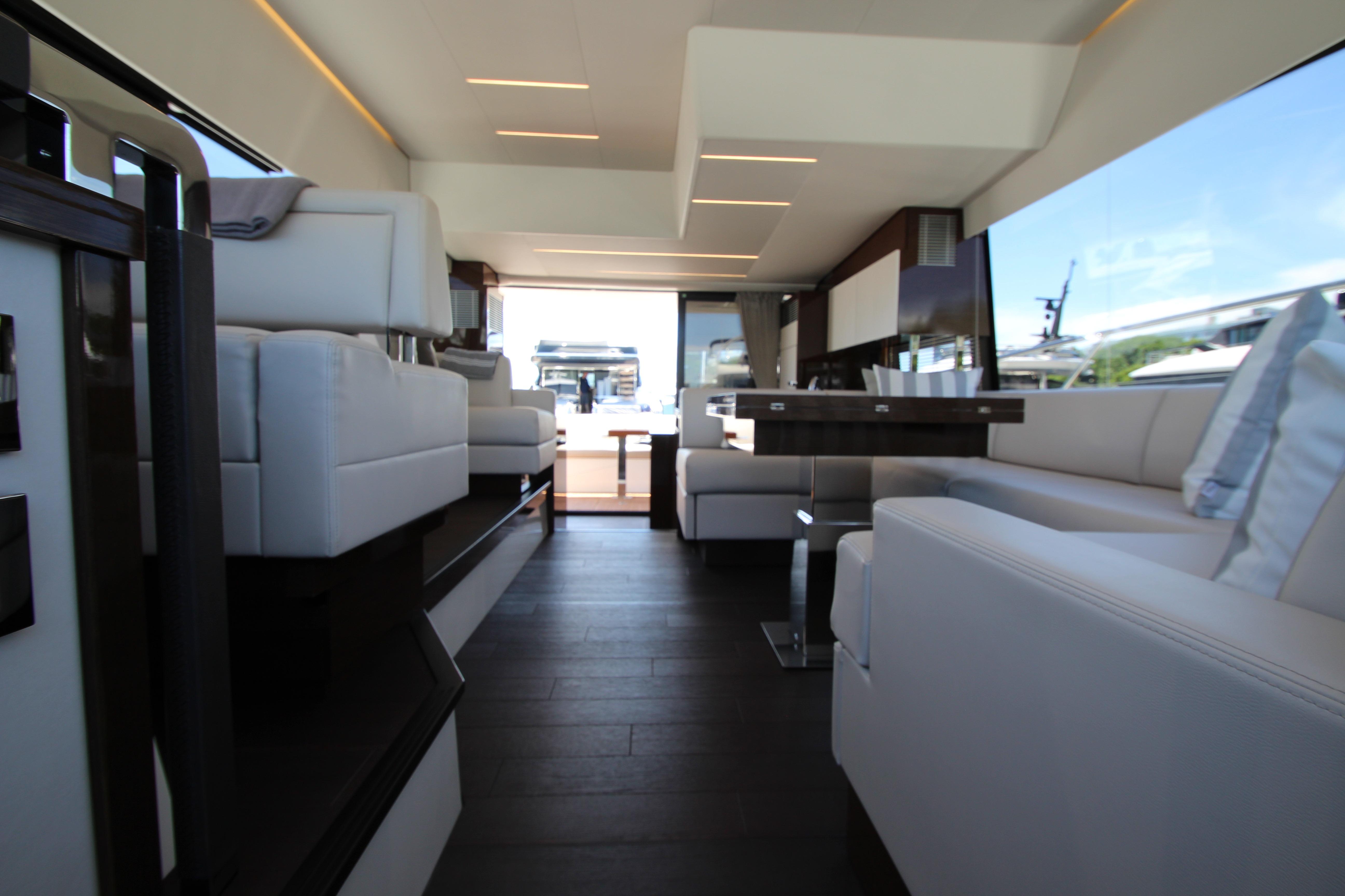 Luxurious interior of a 2022 Prestige 520 yacht, featuring elegant seating and modern design.