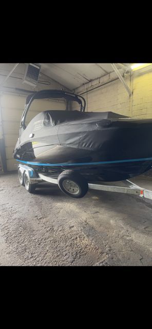 Yamaha 212S boat 2021 on trailer in garage.