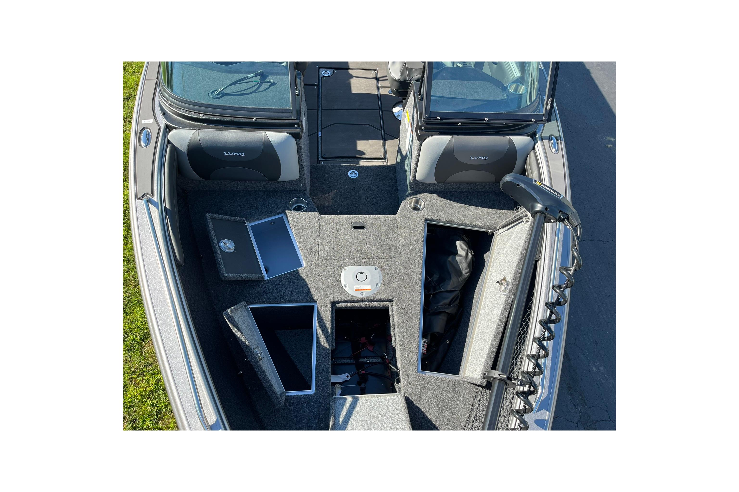 2026 Lund 2275 Baron boat interior with open storage compartments and seating.