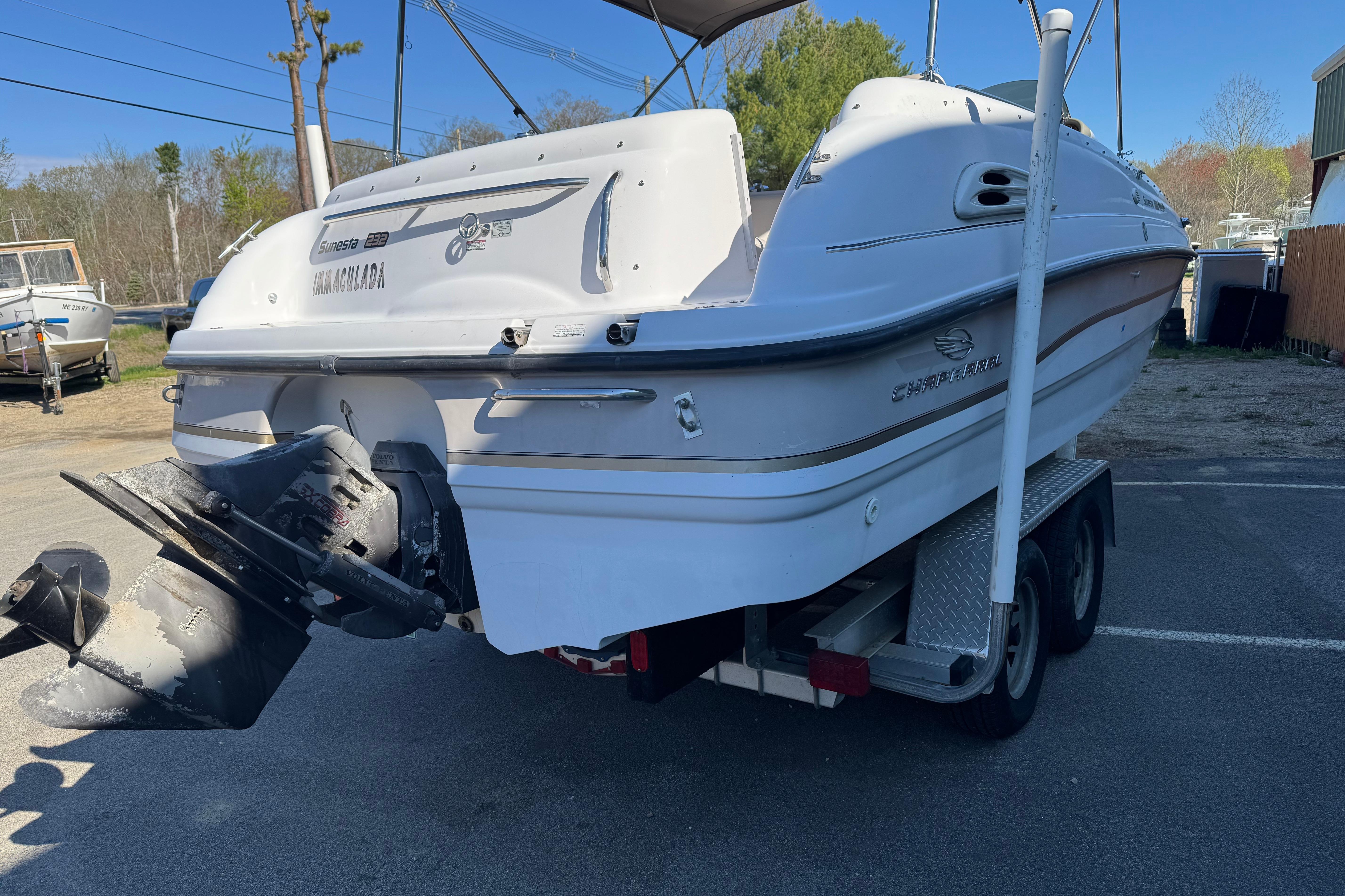 1997 Chaparral 232 Sunesta boat on trailer, rear view, parked outdoors.